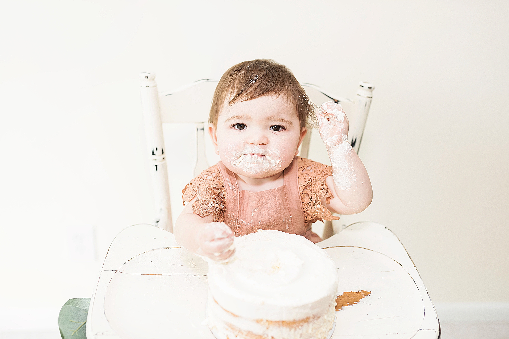 child smashing their first cake