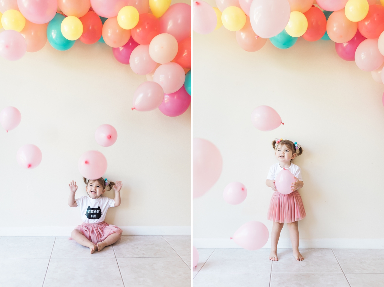 child with pink balloons