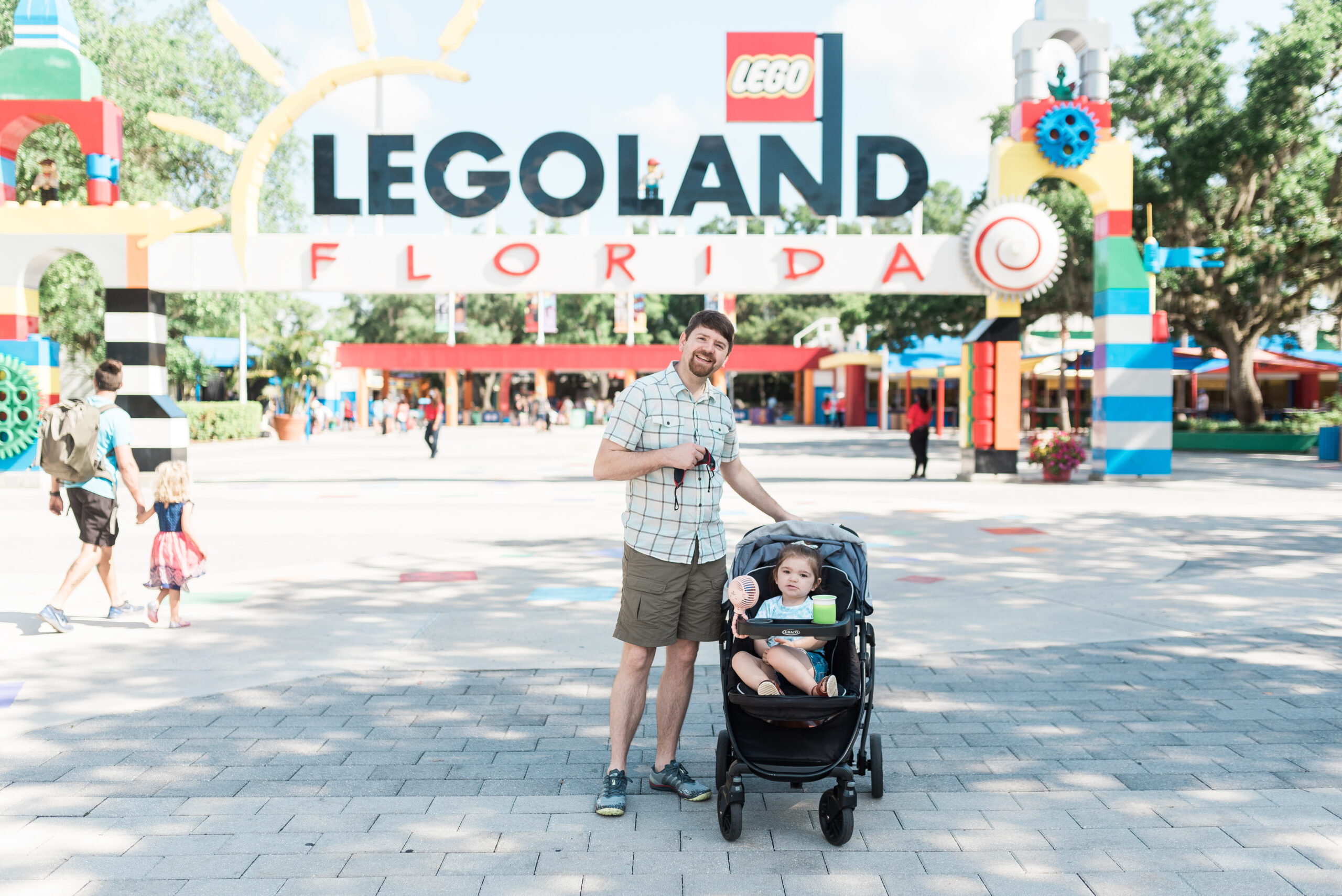 John Naylor and daughter in stroller standing outside entrance of LEGOLAND Florida