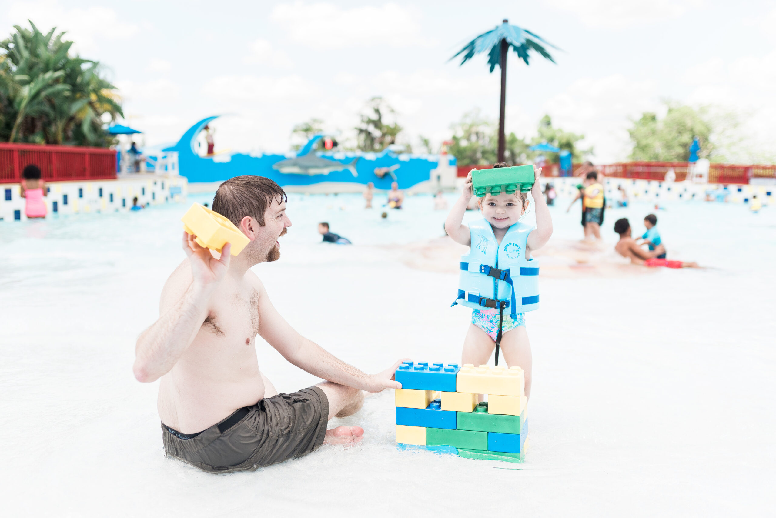 John Naylor and daughter playing in the wave pool with giant brick LEGOS at LEGOLAND waterpark