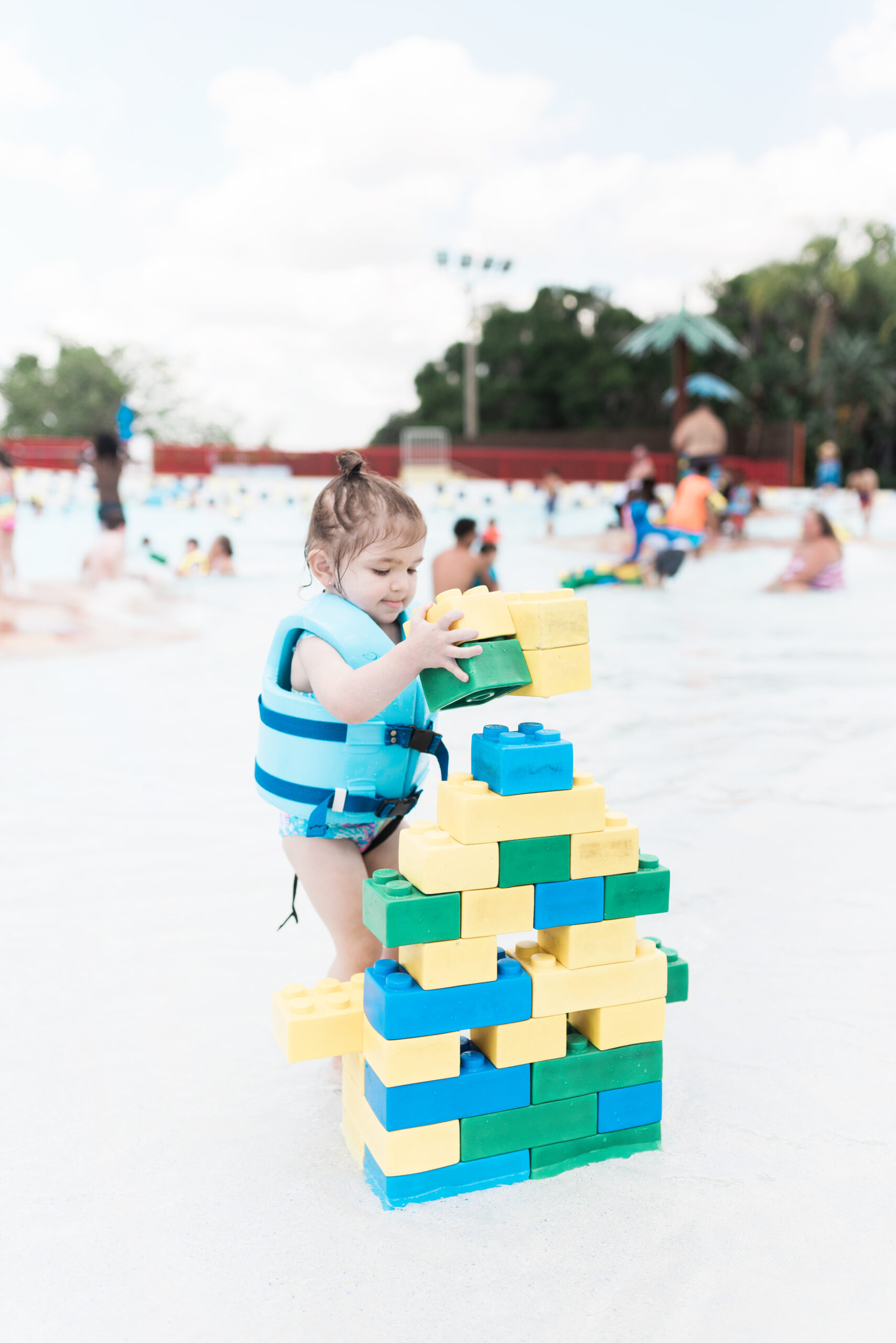 toddler playing with giant legos at wave pool at legoland florida waterpark