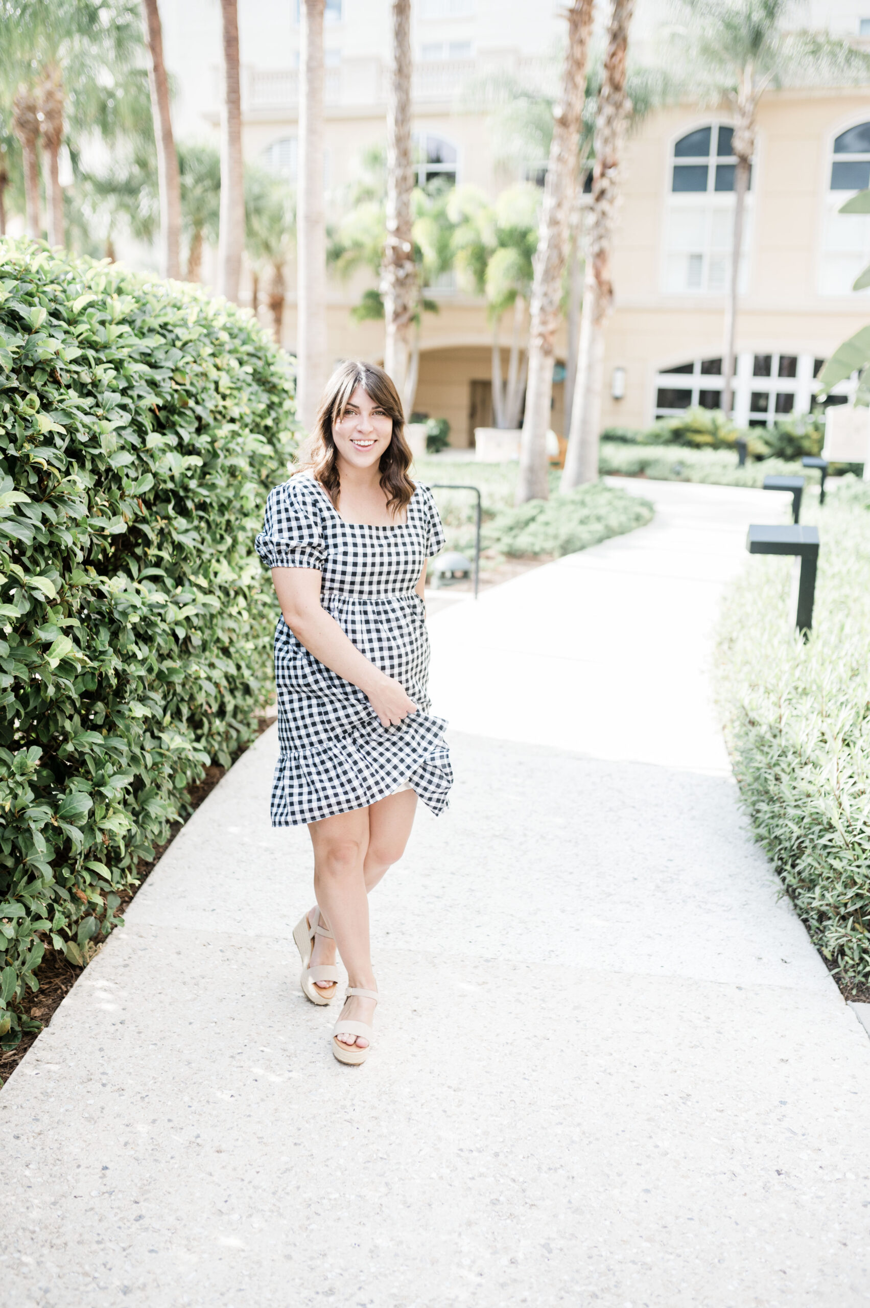 brittney naylor in black checkered dress at the courtyard area of gaylord palms in kissimee