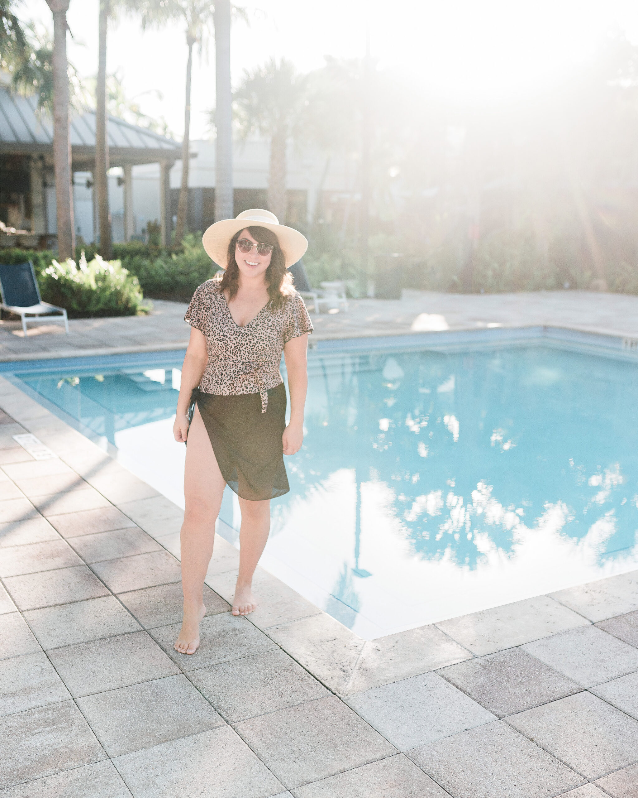 Brittney Naylor in swimsuit and hat standing near pool at The Gates Hotel in Key West Florida