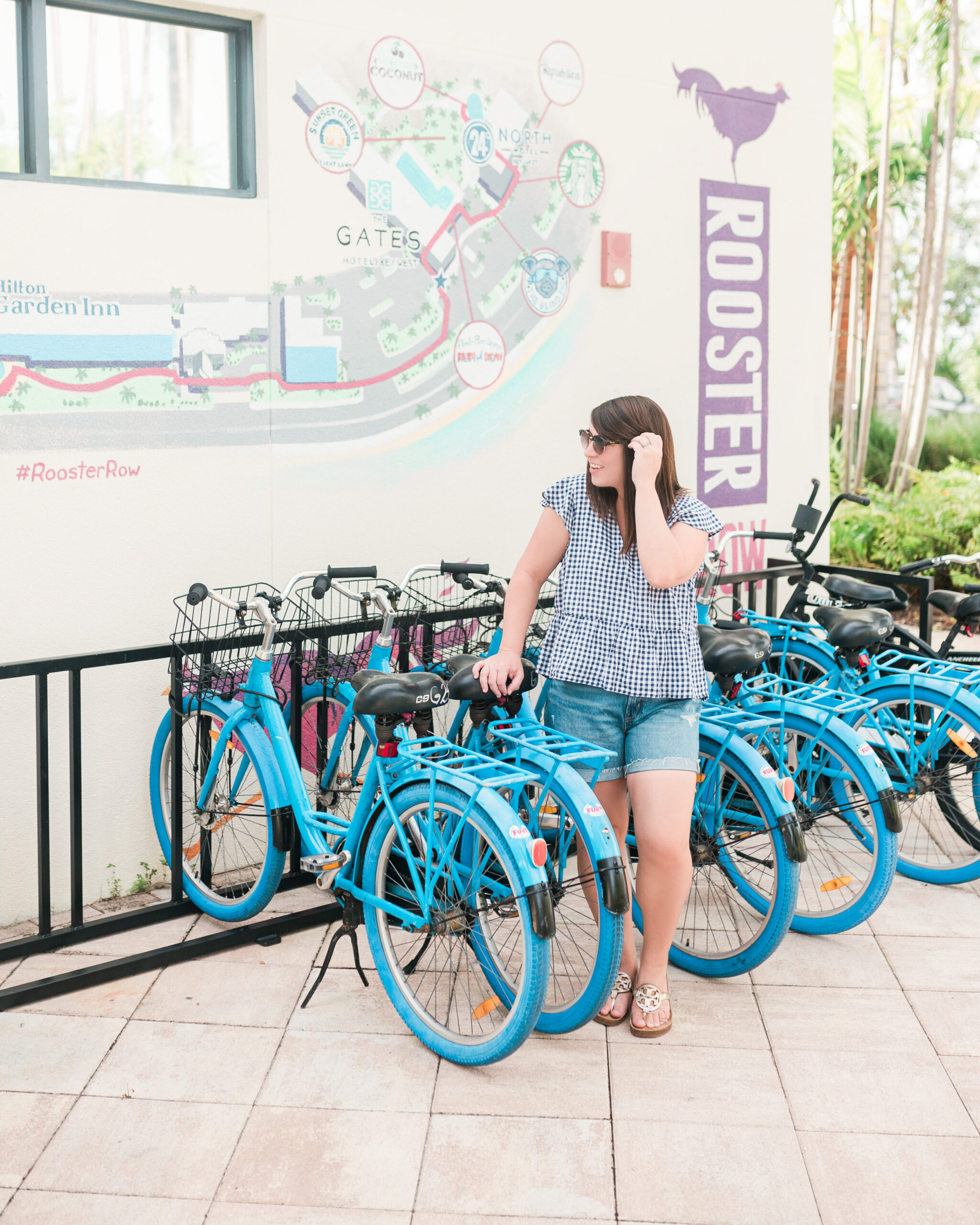 Brittney Naylor standing between bikes in Key West at The Gates Hotel