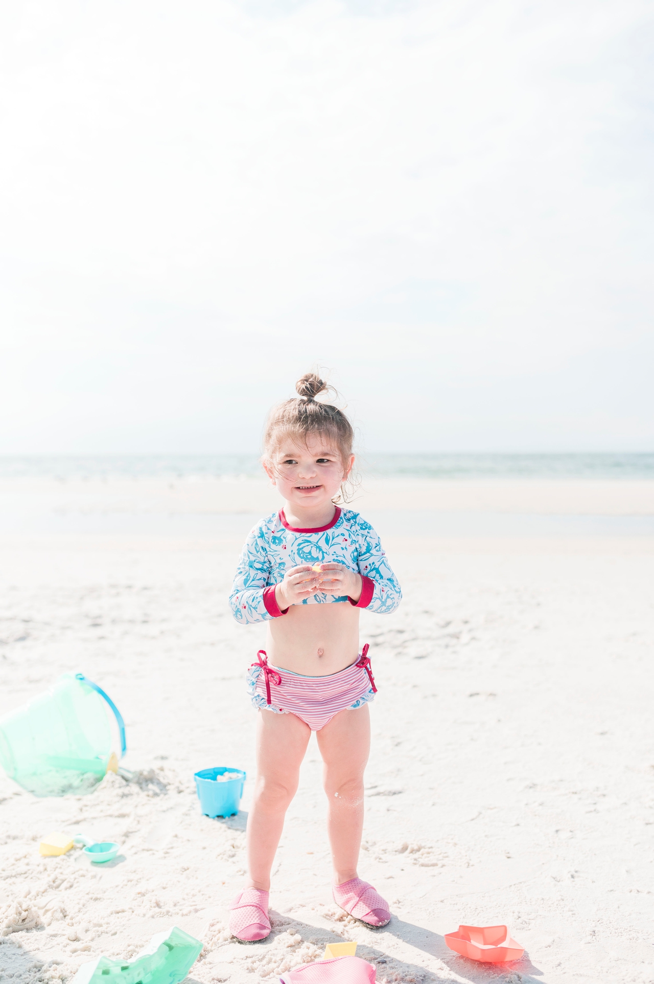 gulf shores alabama beach, little girl playing in the sand with beach toys, backwards beach day ideas