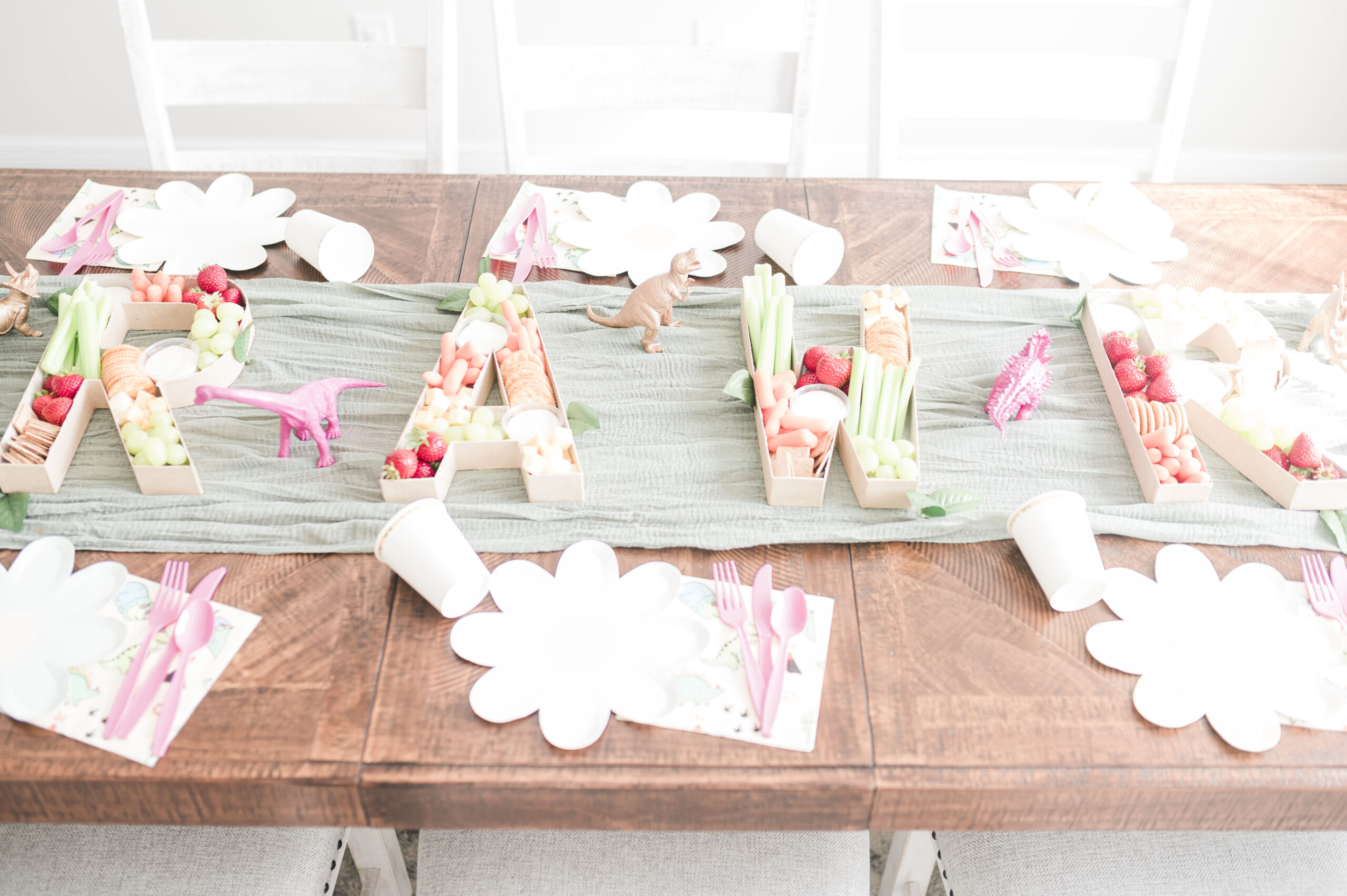 veggies in paper mache letters spelling out RAWR for three rex birthday party for girl