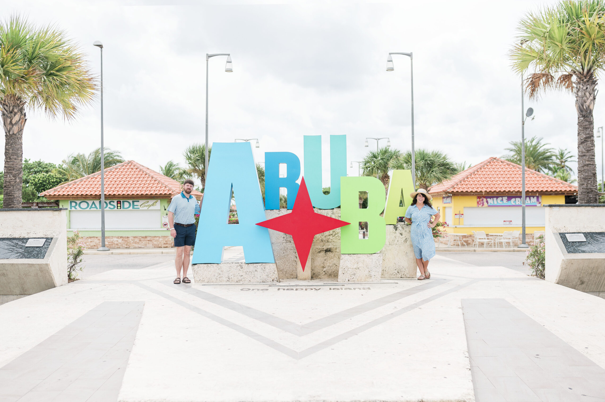 standing in front of Aruba sign in Aruba