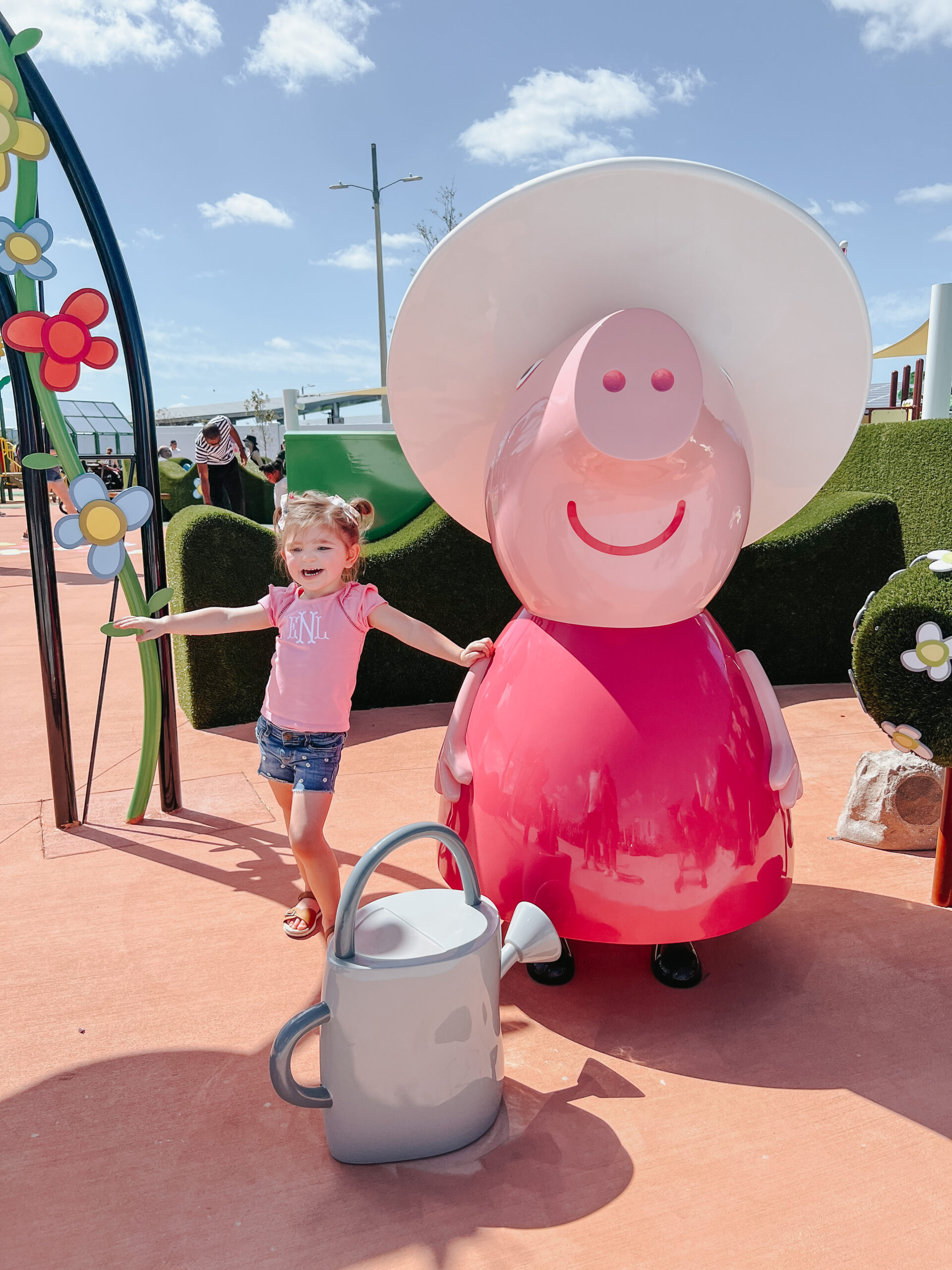 little girl in pink standing next to granny pig from peppa pig
