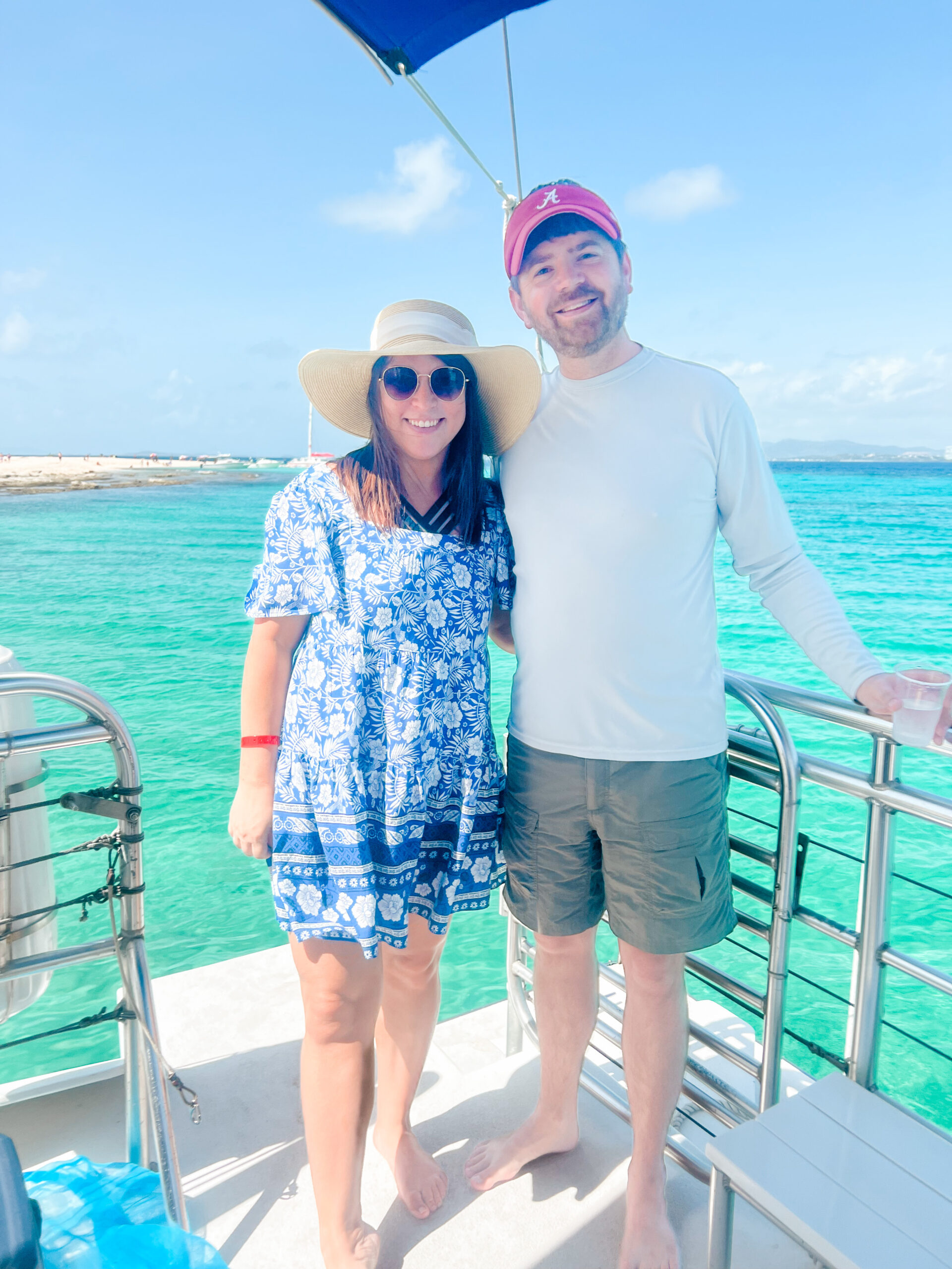 male and female posing for image on catamaran on ocean