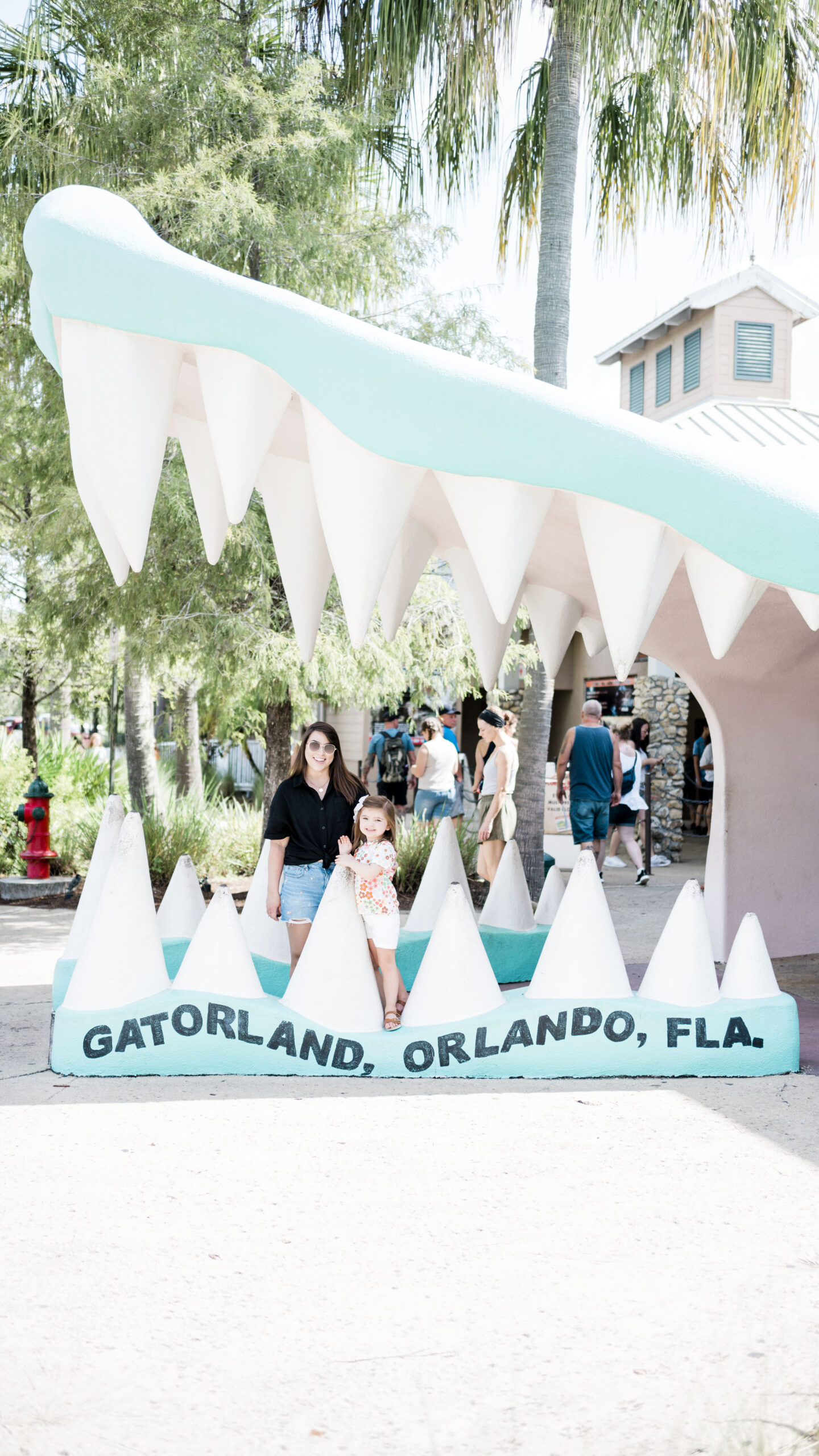 woman and child standing in gator mouth at gatorland