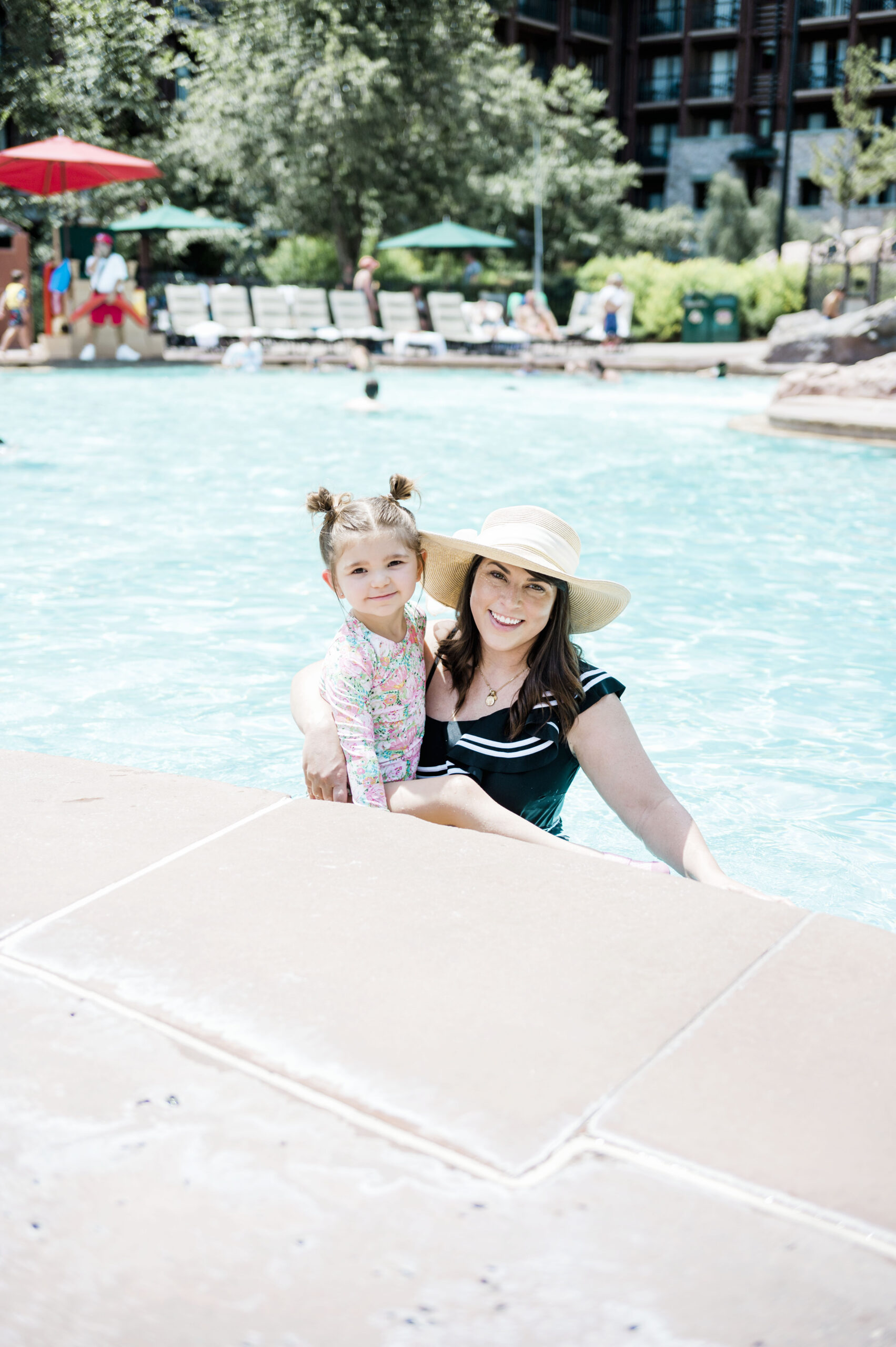 brittney naylor in black one piece swimsuit with daughter at pool at copper creek wilderness lodge. Best Family Resort in Florida, Orlando Staycations