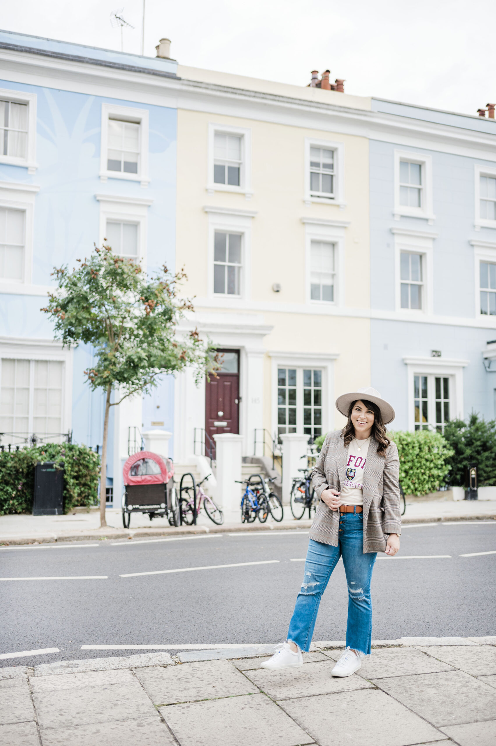 brittney naylor wearing jeans, brown blazer, hat, in notting hill london