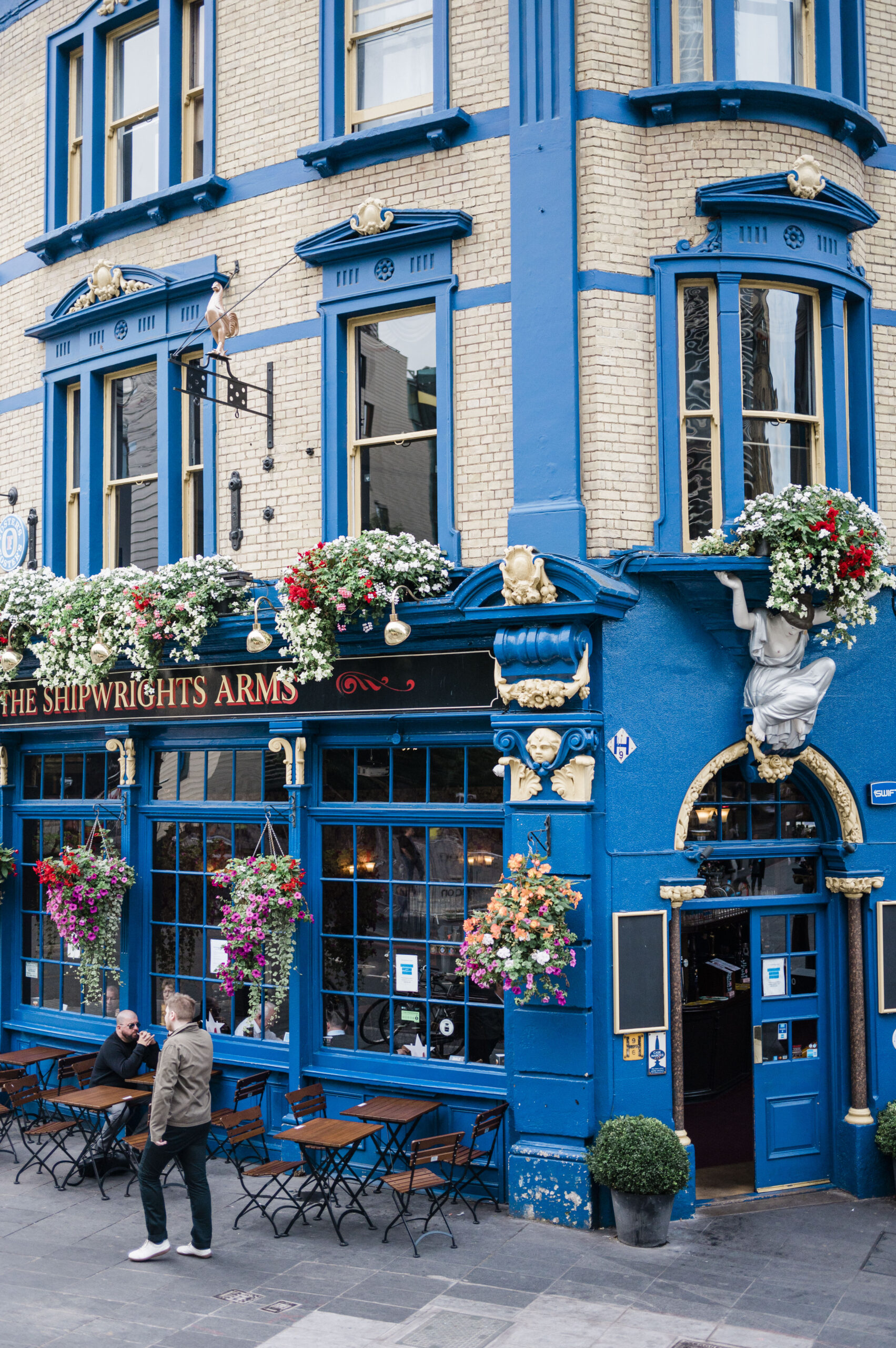 blue building with flowers in downtown london