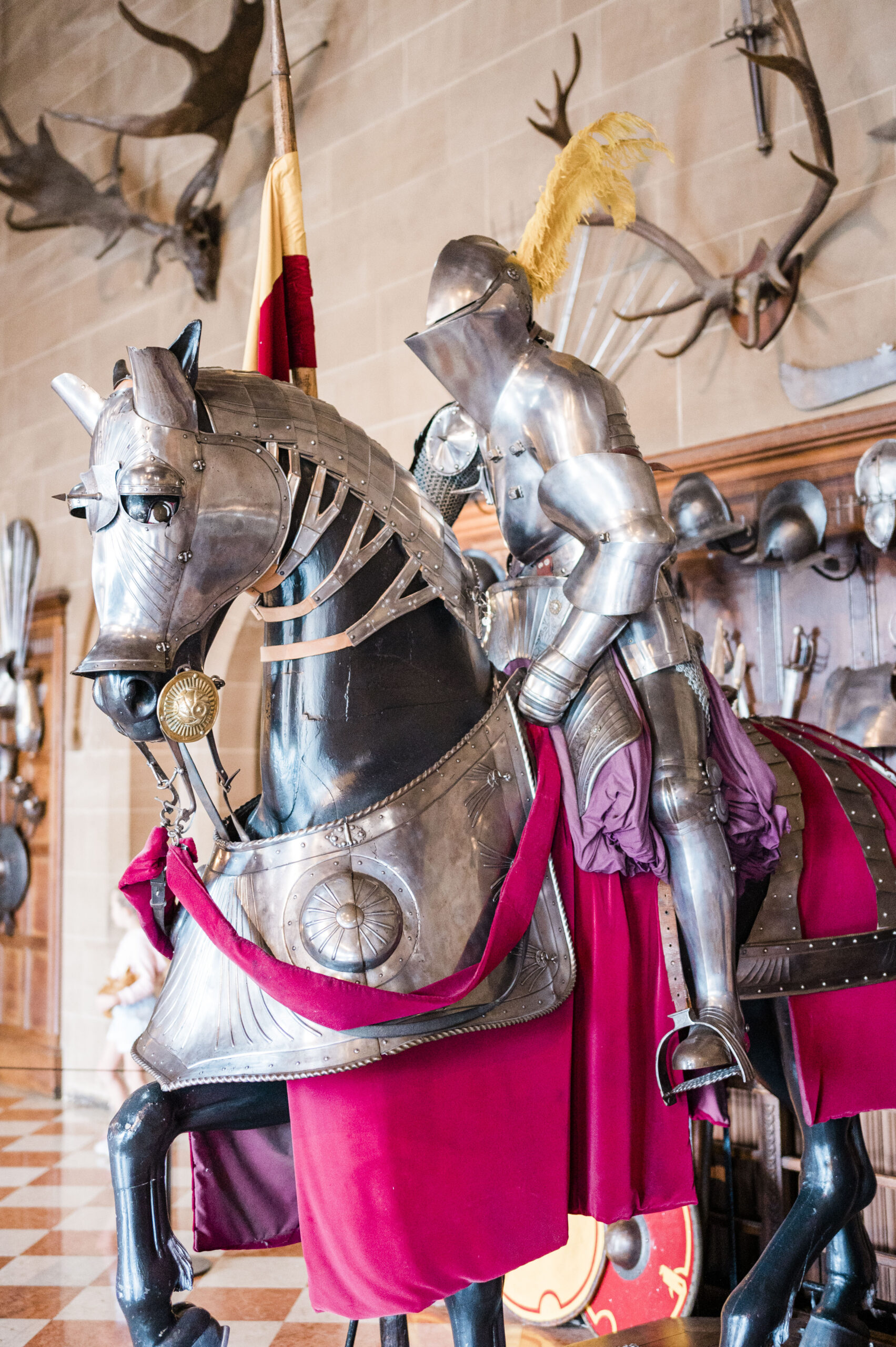 knight in armor on a replica horse at warwick castle