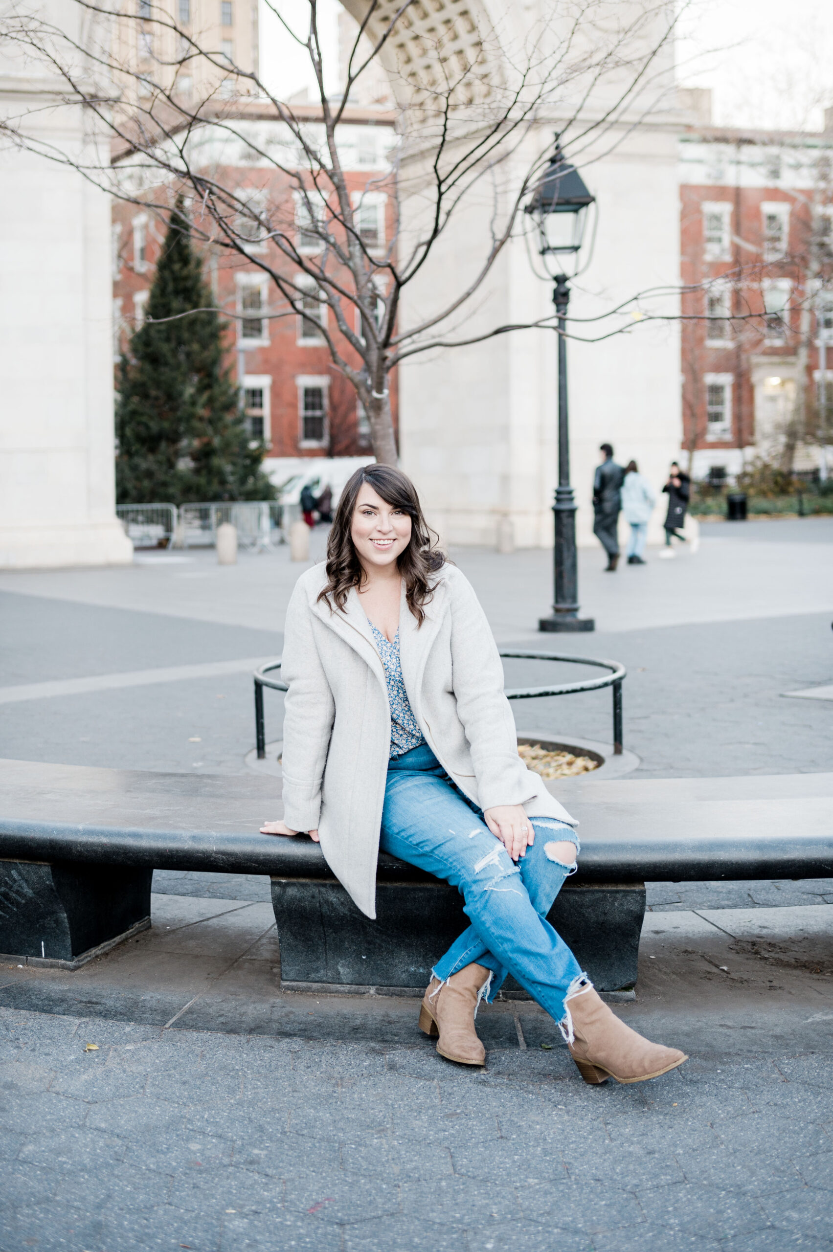Brittney Naylor sitting in front of the Washington Square Arch in New York City