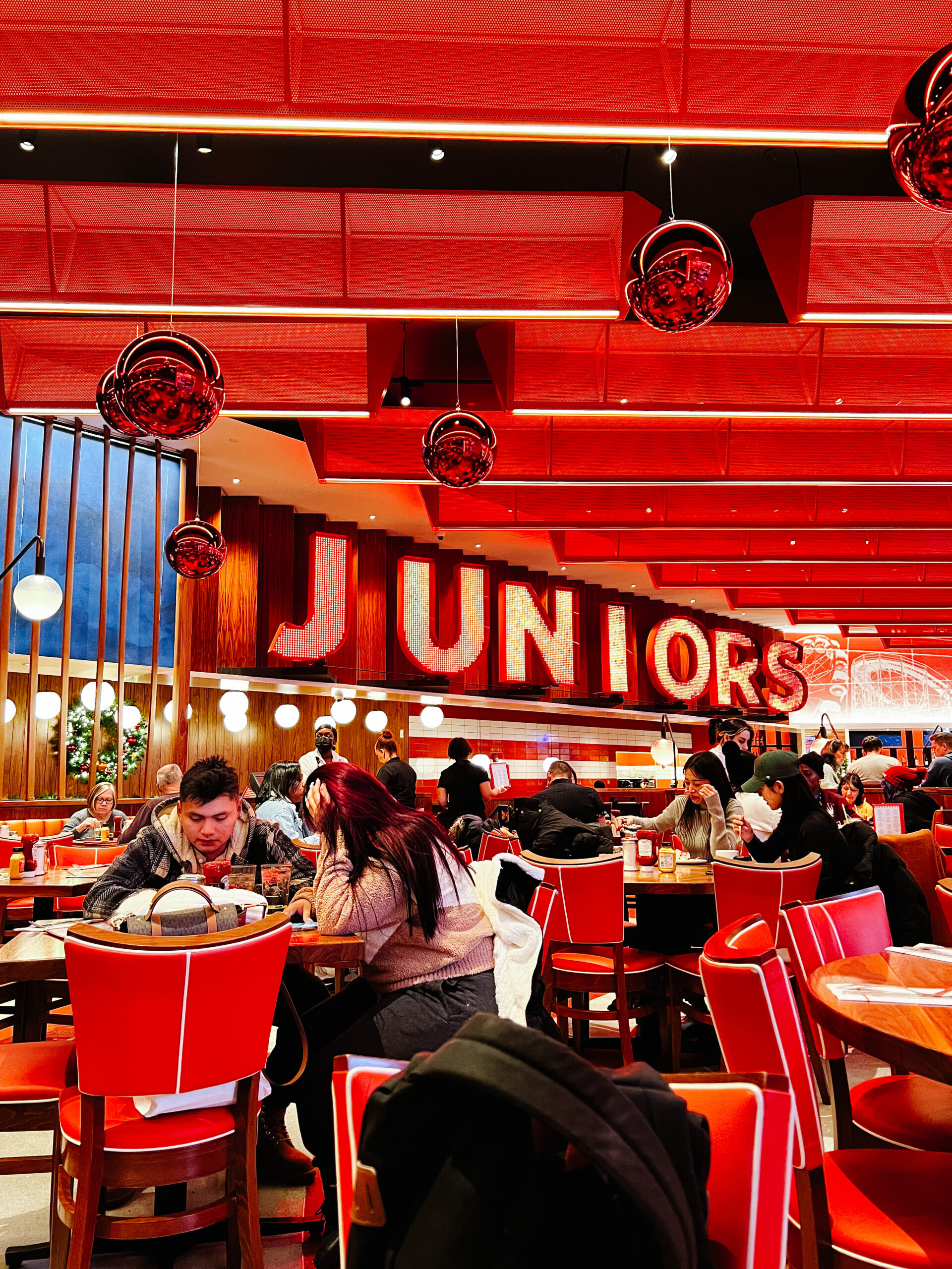interior of Junior's restaurant in New York City with marquee lights spelling out Juniors