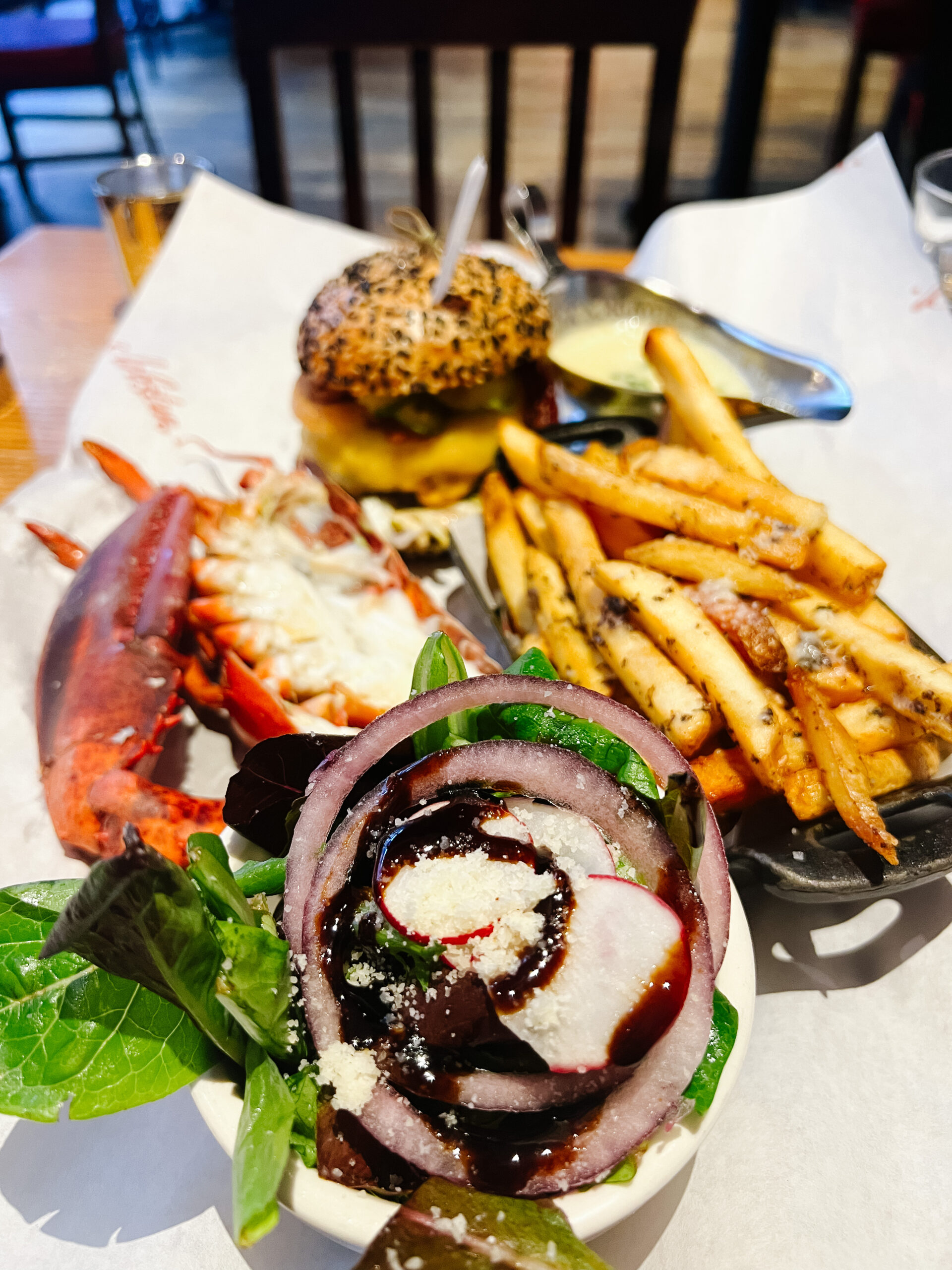 Lobster tail, fries, salad, and burger from Burger and Lobster in New York City.