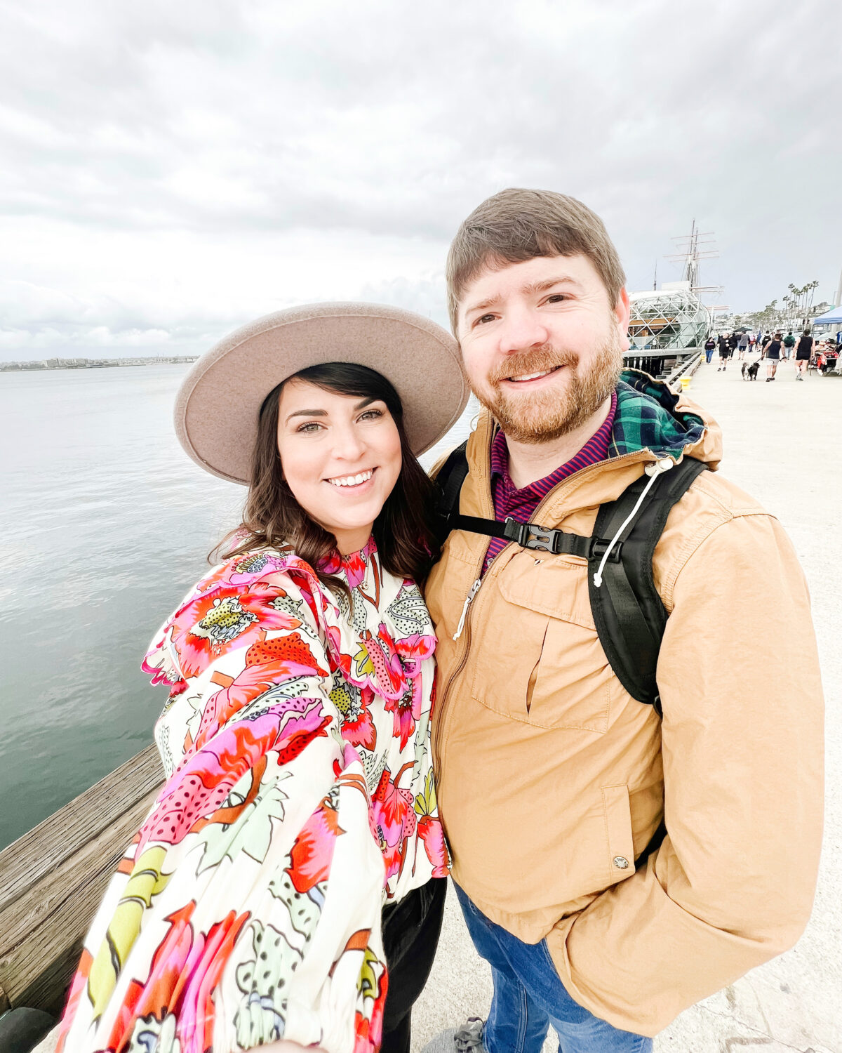 John and Brittney Naylor standing beside San Diego Bay