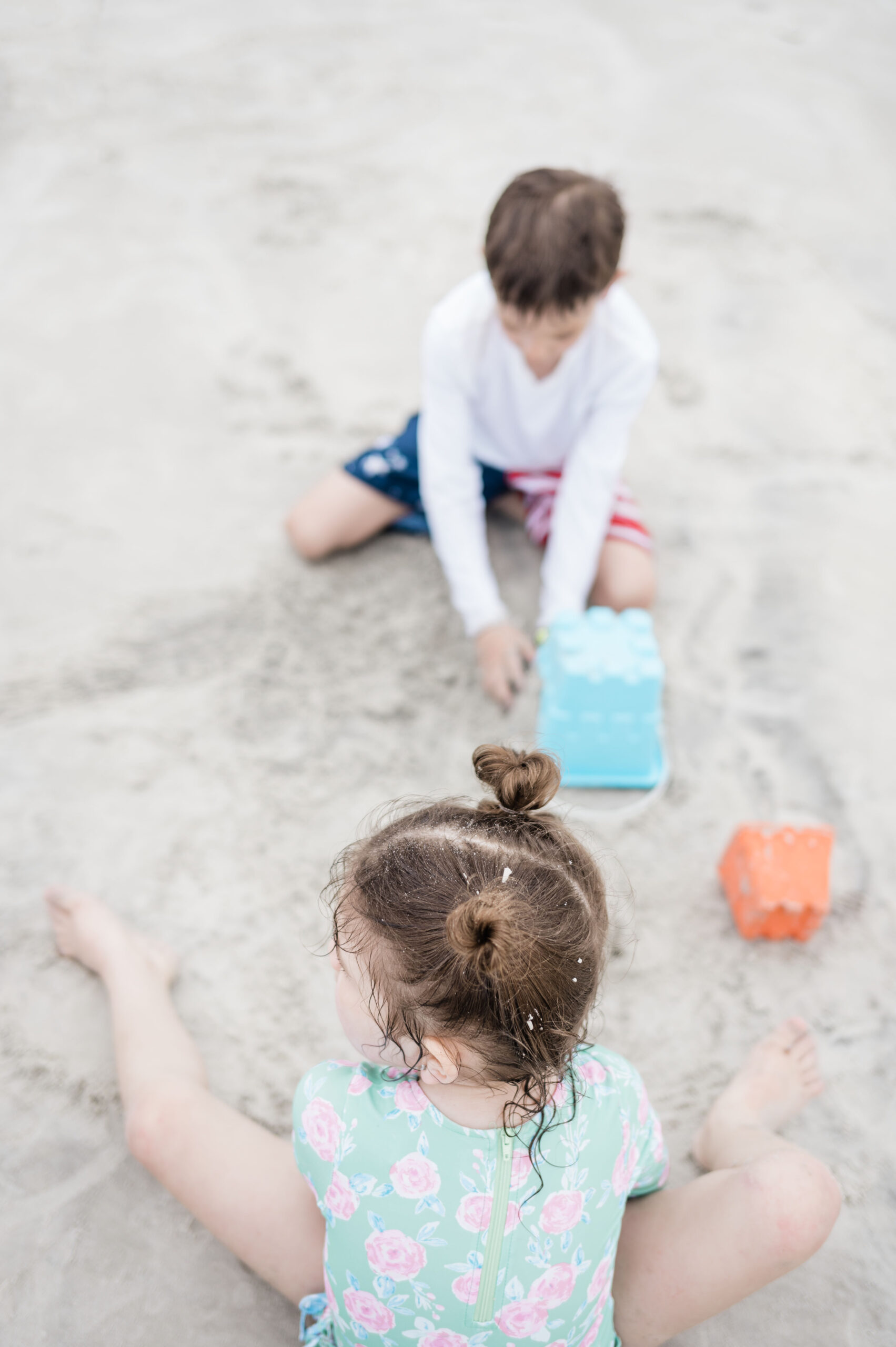 two kids playing in the sand in saint Augustine beach florida