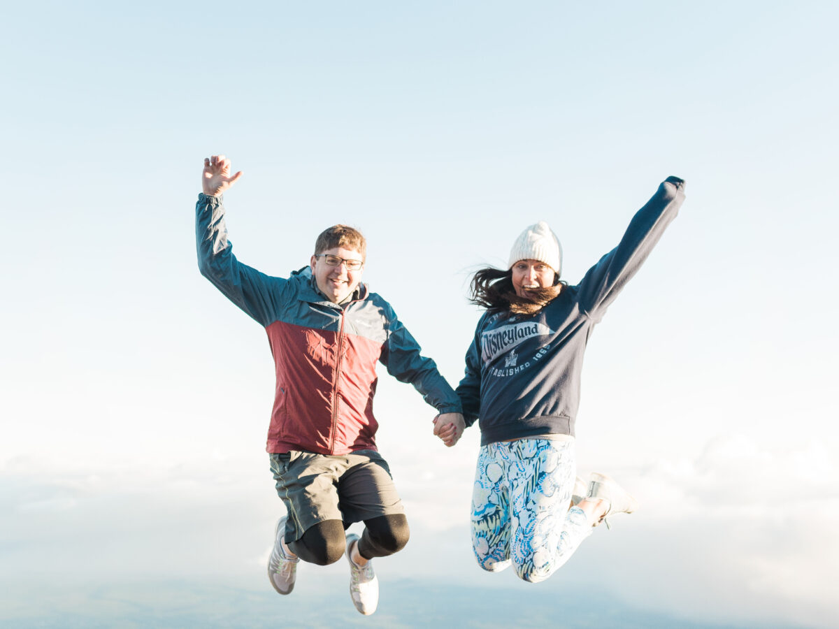 John and Brittney Naylor jumping in the air at the top of Haleakala National Park in Maui Hawaii