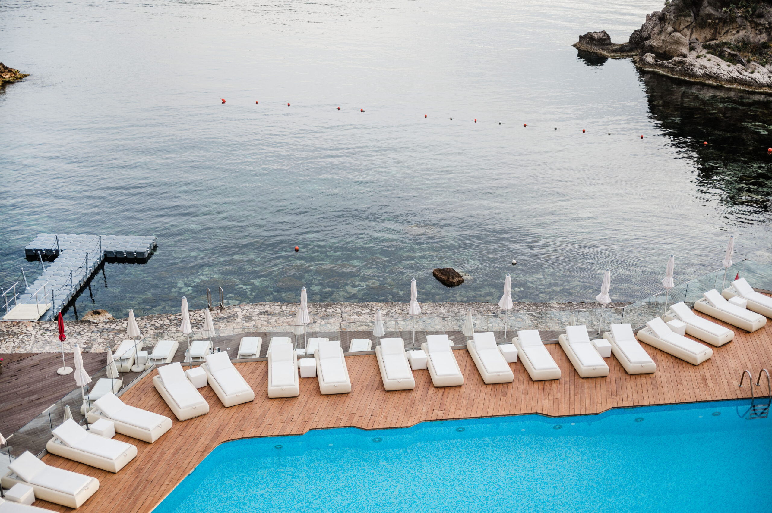pool and sea view from the balcony at atlantis bay in taormina, sicily