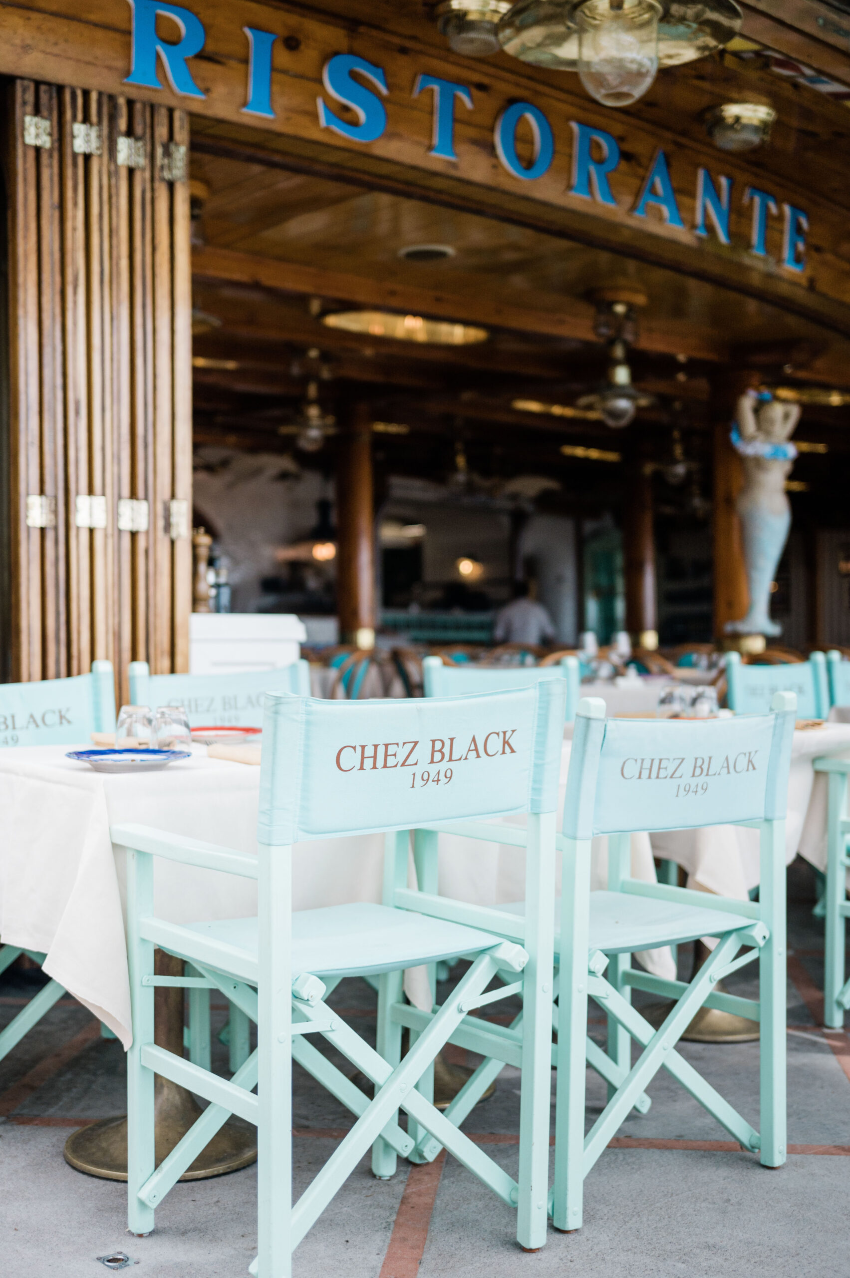 View of the chairs at Chex Black, tiffany blue with Chez Black in gold letters