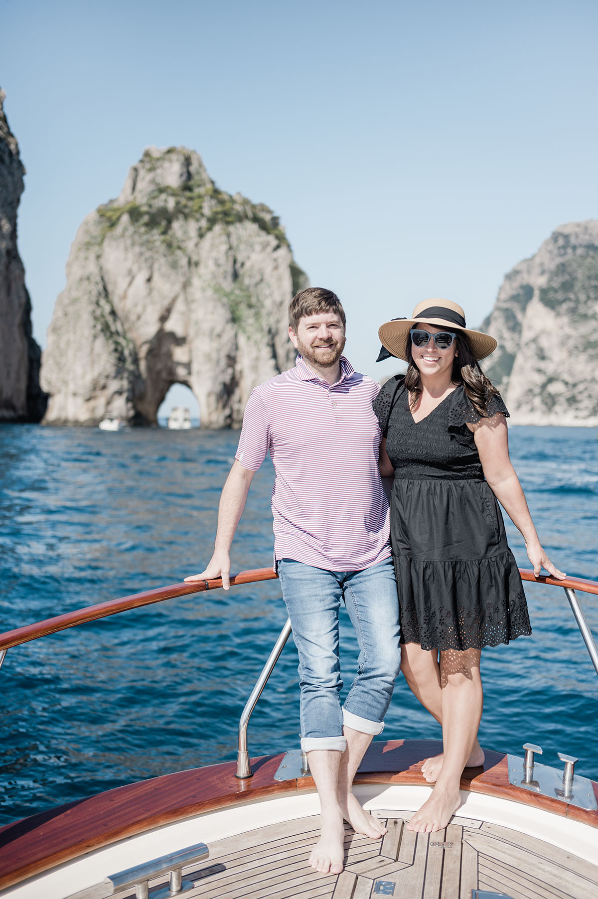 John and Brittney Naylor standing at the head of a boat on a private boat tour to Capri island from Positano