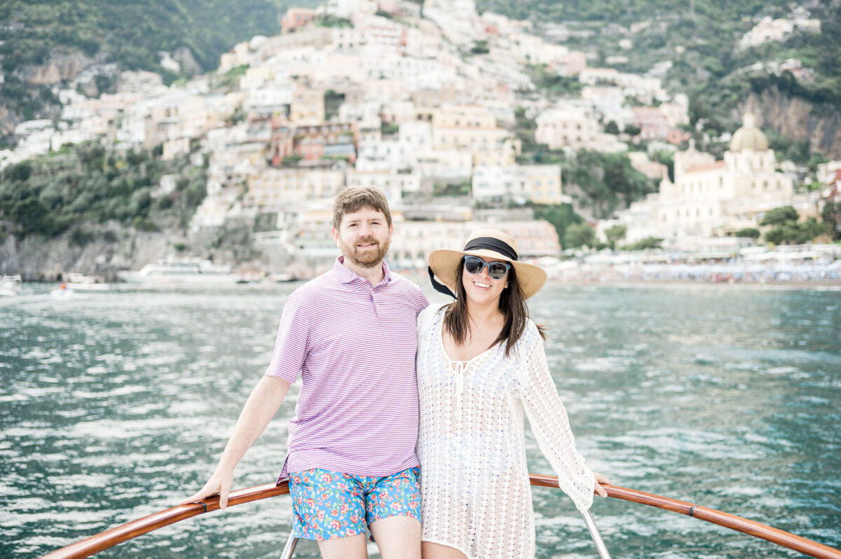 John and Brittney Naylor on a boat with Positano behind them, private boat tour positano