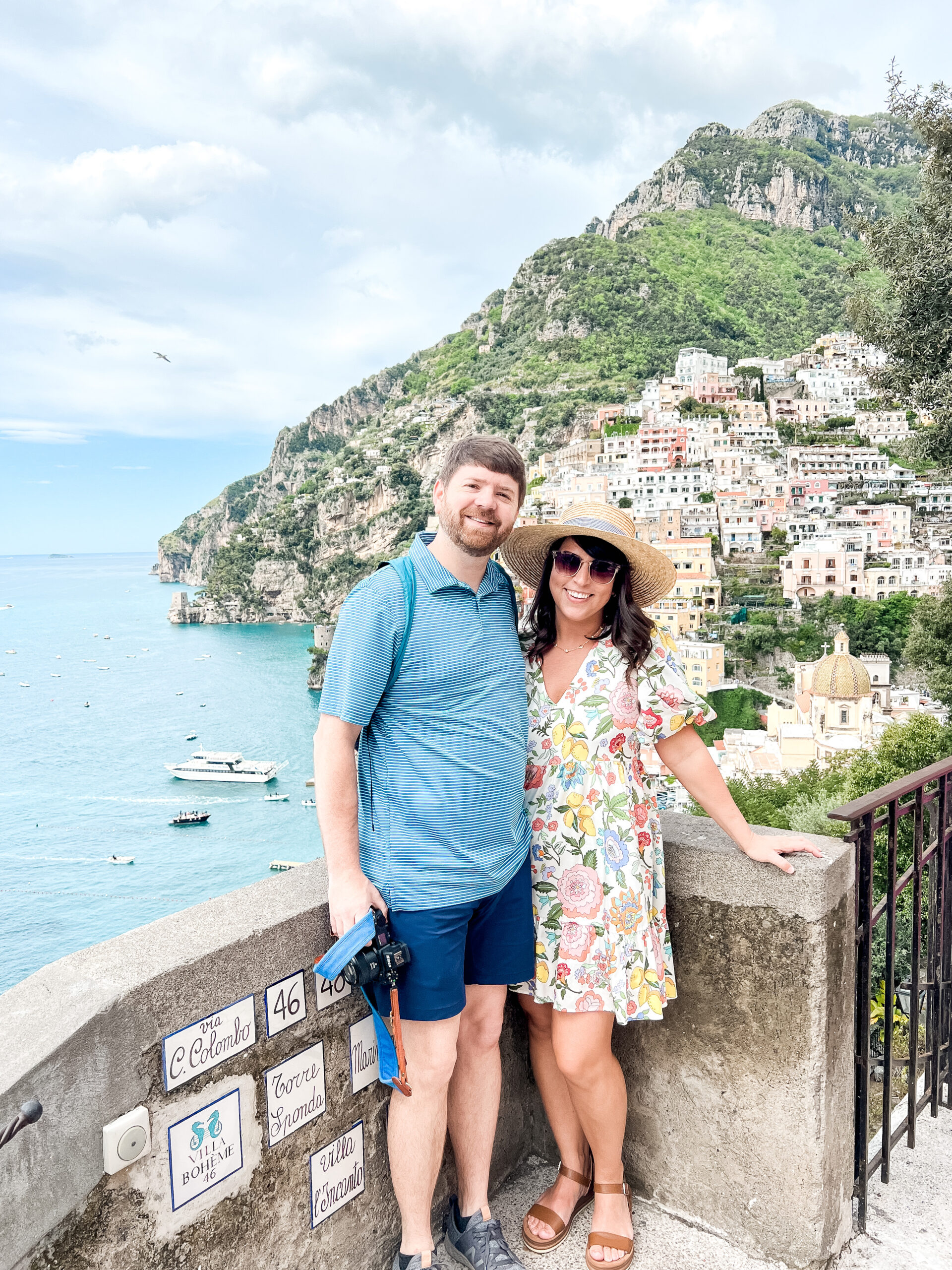 John and Brittney Naylor posed together with Positano hillside and water behind them. 3 days in Positano as First-Timers