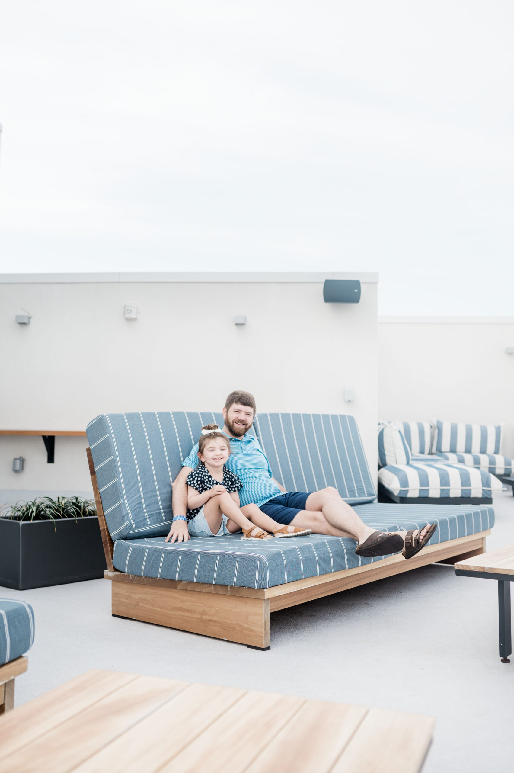 John and Eleanor sitting on outdoor couch on the rooftop area at Max Daytona Beach Resort.