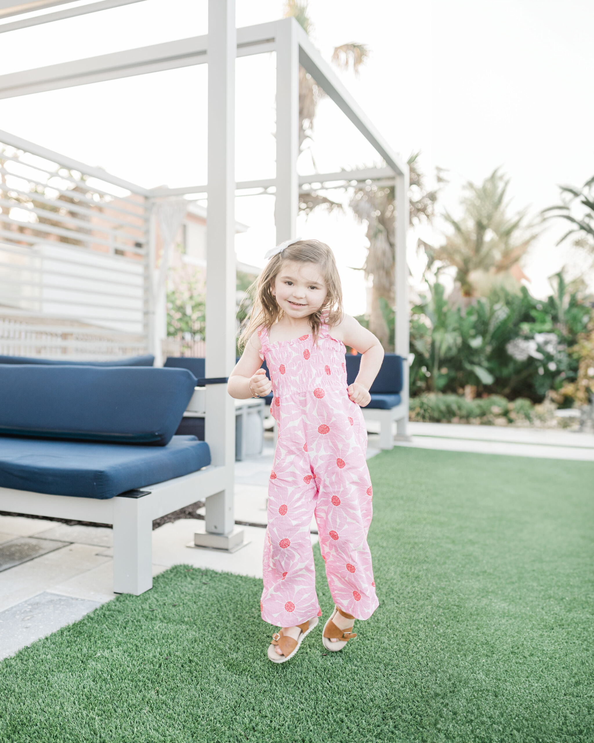 Eleanor dancing in pink jumpsuit in the cabana area at Max Daytona Beach resort