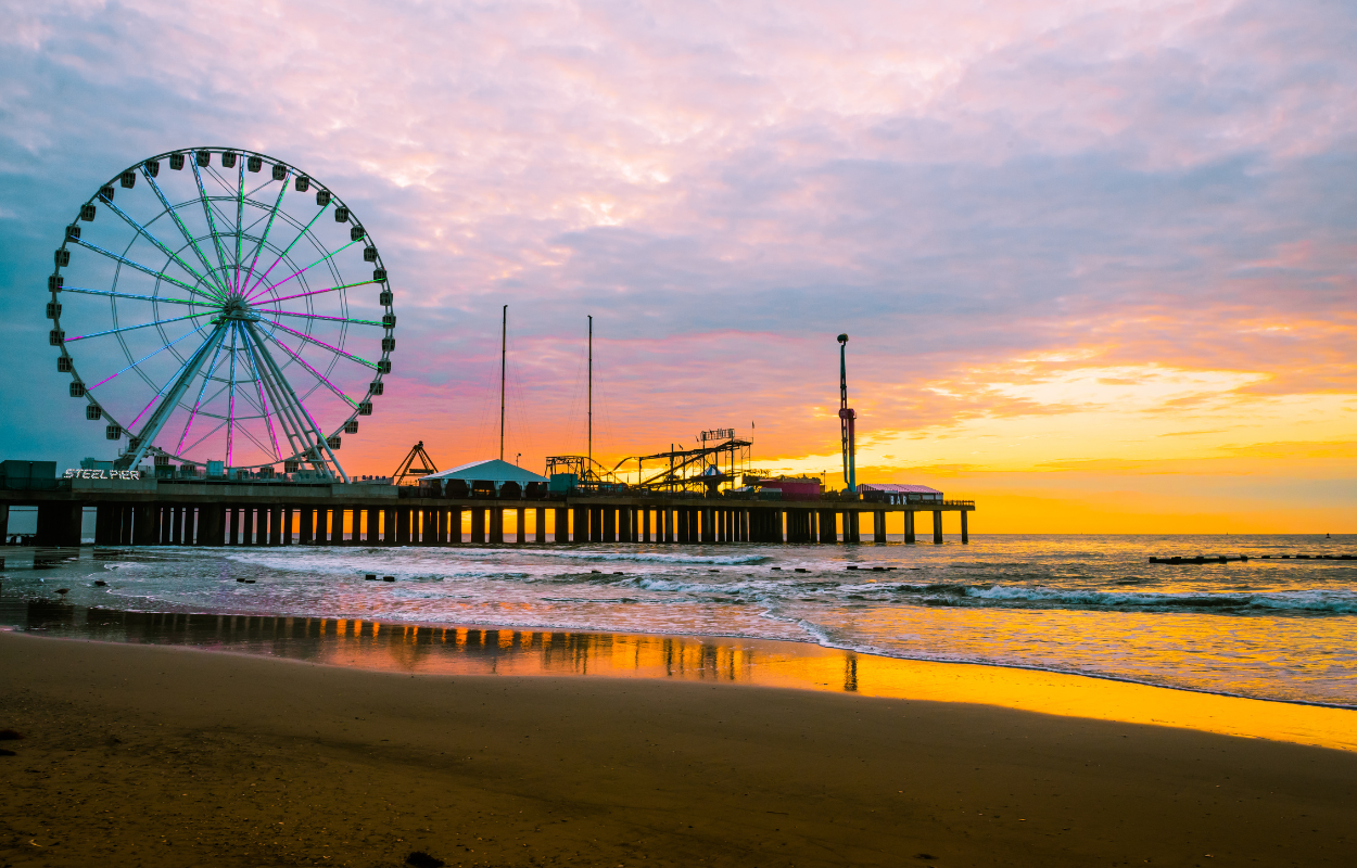 Steel Pier in Atlantic City on the Jersey Shore, New Jersey. Sunset views of the pier with the ferris wheel and more. Best Vacation Destinations for families in the USA.