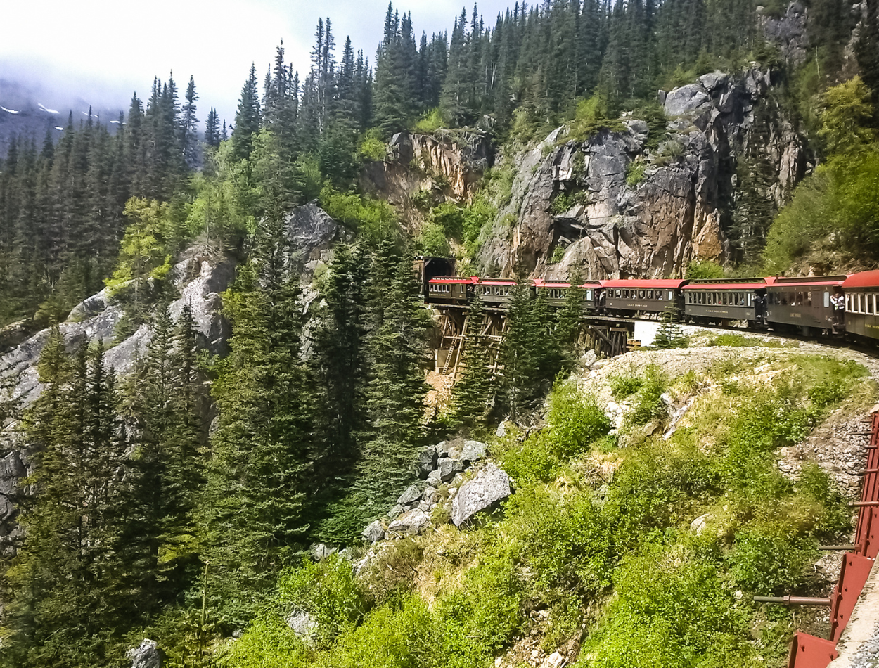 The train in Skagway, Alaska--the White Pass & Yukon Route Railway. View picturesque mountains and scenery. Best family vacation destinations in the USA.
