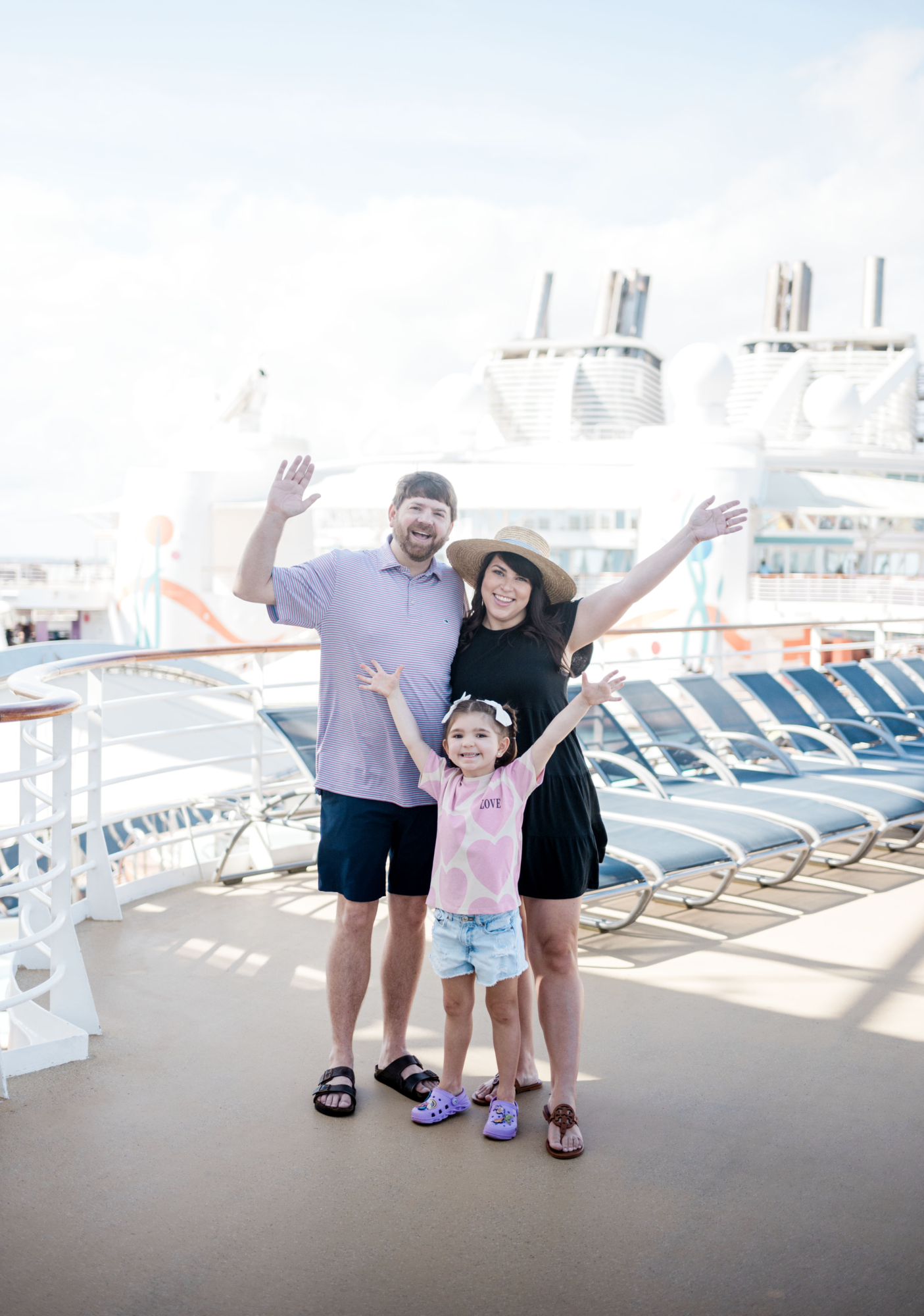 Amazon Cruise Essentials for Families--The Naylor family on board a Royal Caribbean Cruise deck with their arms up in the air. Stress-free cruising with Kids.