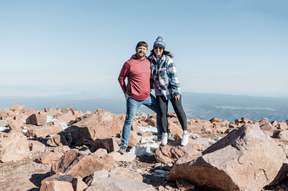 Ultimate weekend in Colorado Springs for couples--John and Brittney Naylor standing at the top of Pike's Peak