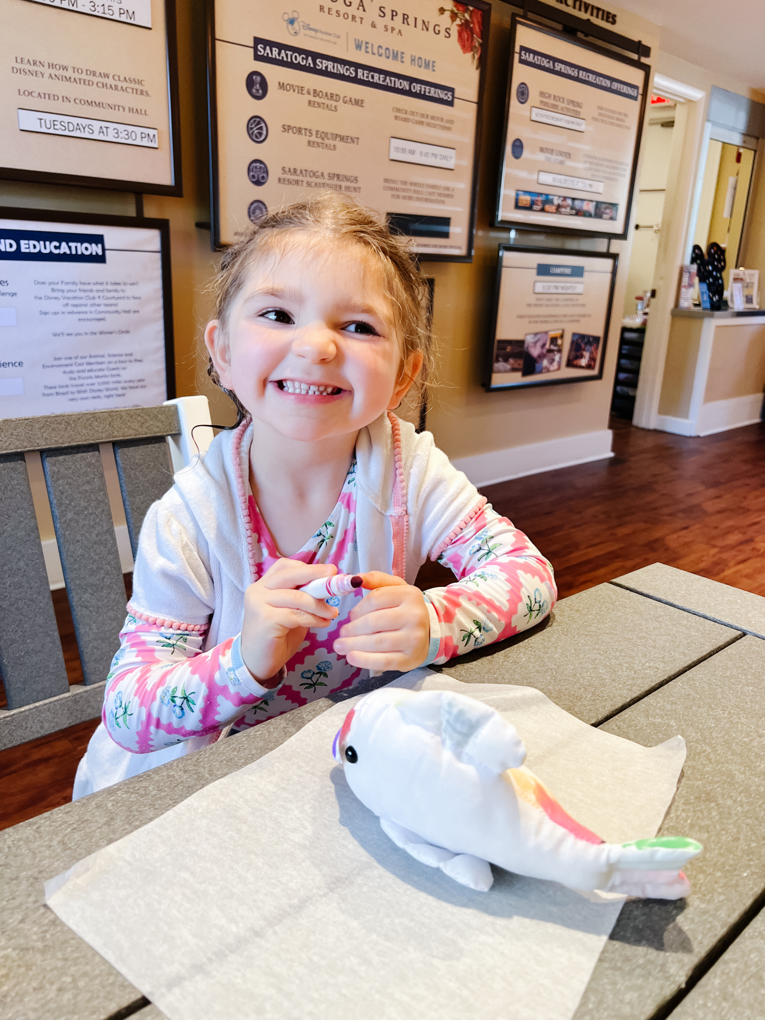 Eleanor coloring a plush animal at the community hall at Disney's Saratoga Springs Resort.