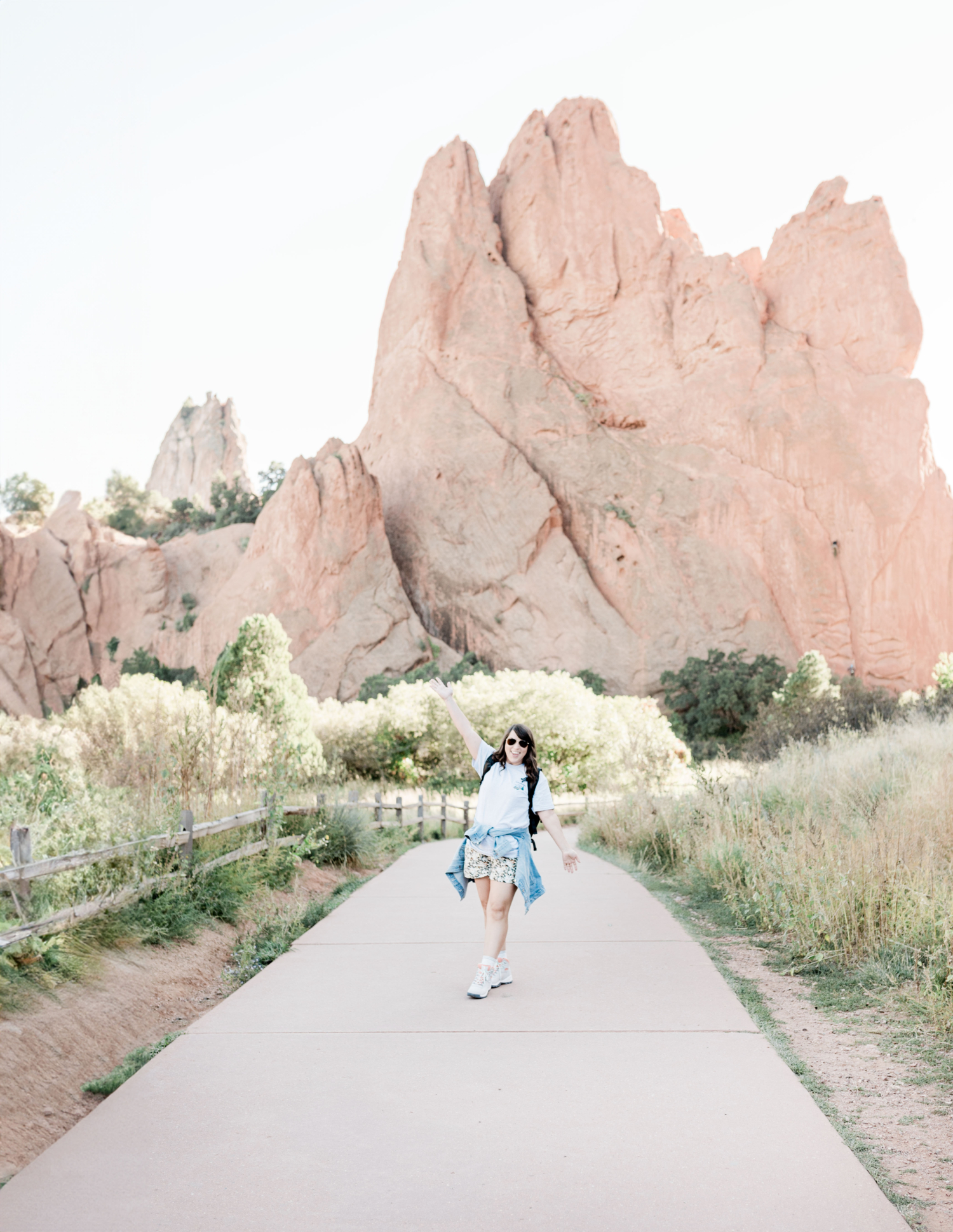 Brittney Naylor standing in front of the Garden of the Gods with arms up--Colorado Springs weekend itinerary for couples, two days in Colorado Springs, Things to do in Colorado Springs