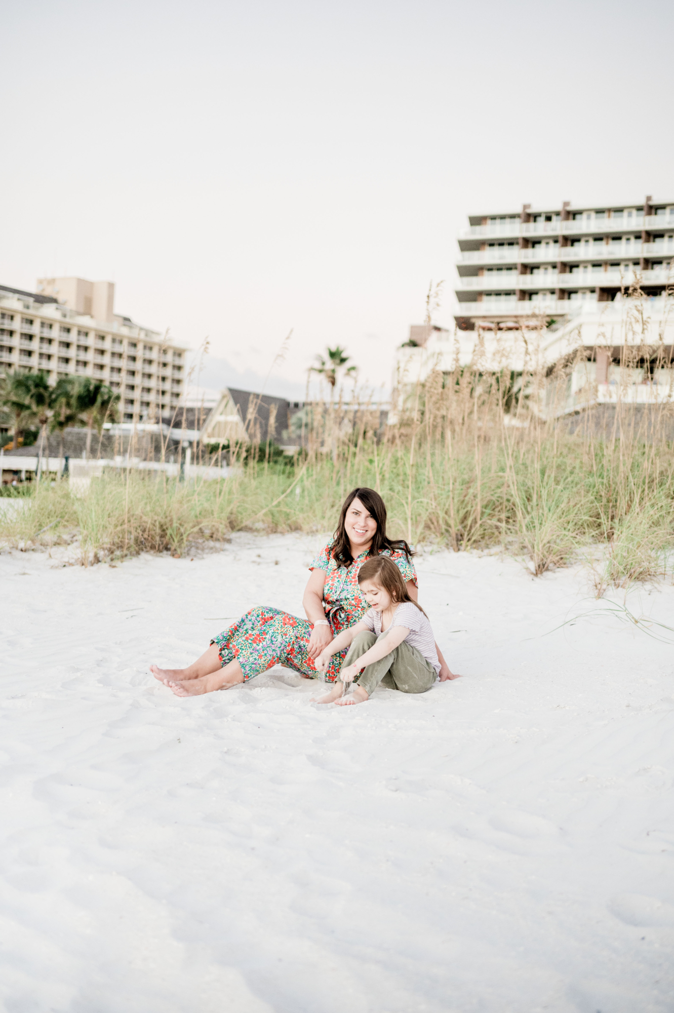Brittney and Eleanor sitting in the sand at JW Marriott Marco Island