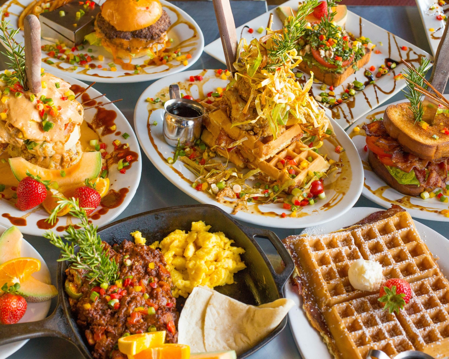 Variety of food on table featured at Hash House A Go Go in Orlando--best family-friendly restaurants in Orlando 
