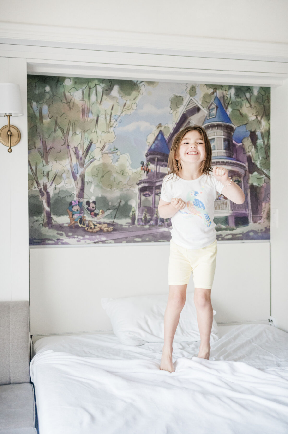 Child jumping on the bed at Saratoga Springs resort--a DVC resort--best Orlando staycations for families