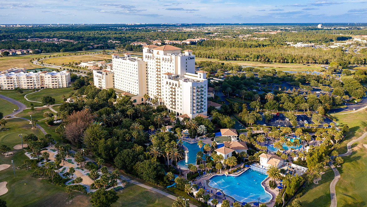 Aerial view of the Omni Orlando Resort at Championsgate featuring the pool and water park, golf course, and hotel. Best Orlando Staycations for families.