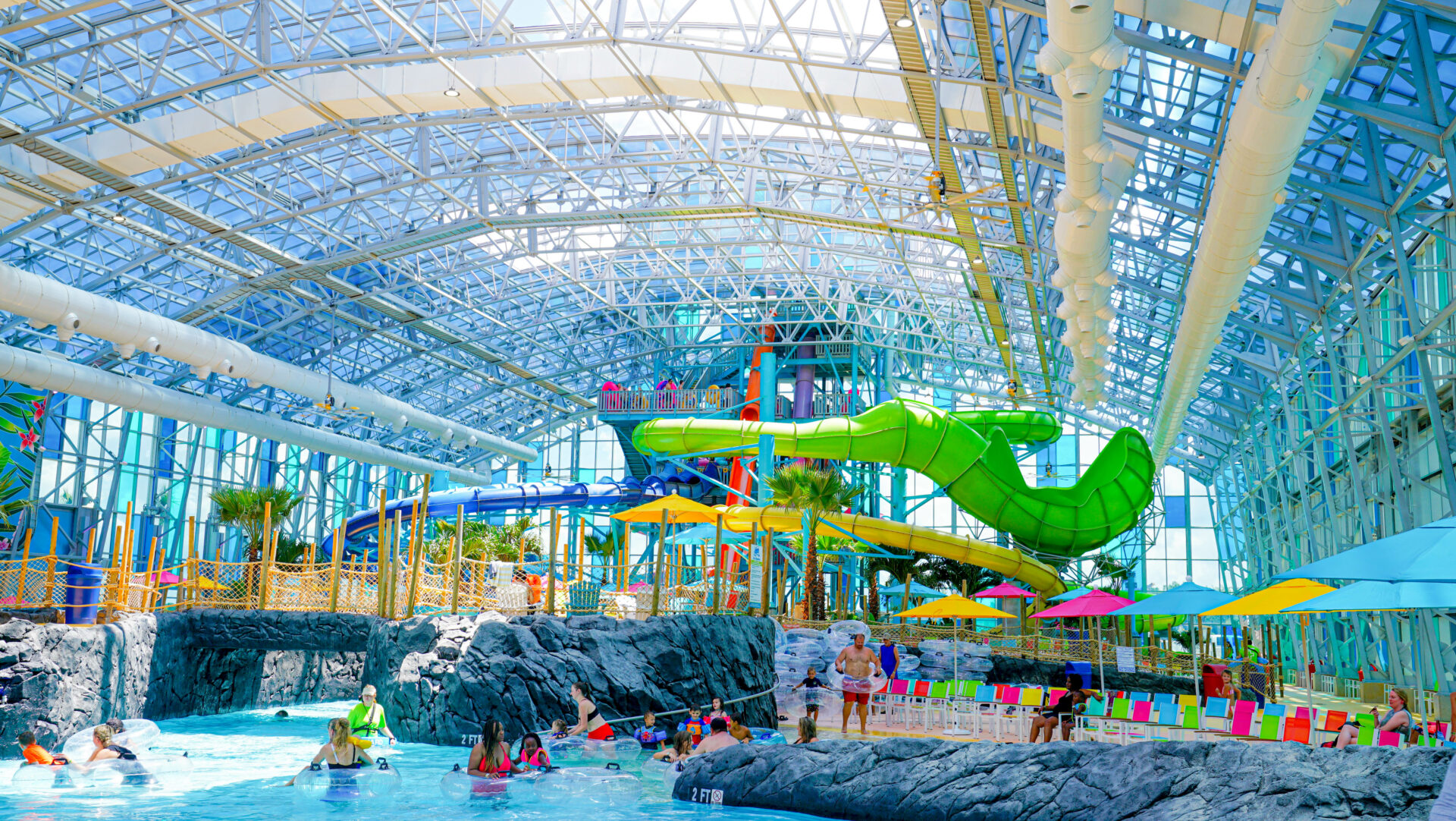 wide angle shot of tropic falls featuring a waterfall, colorful indoor water slides, and more--best family attractions in gulf shores