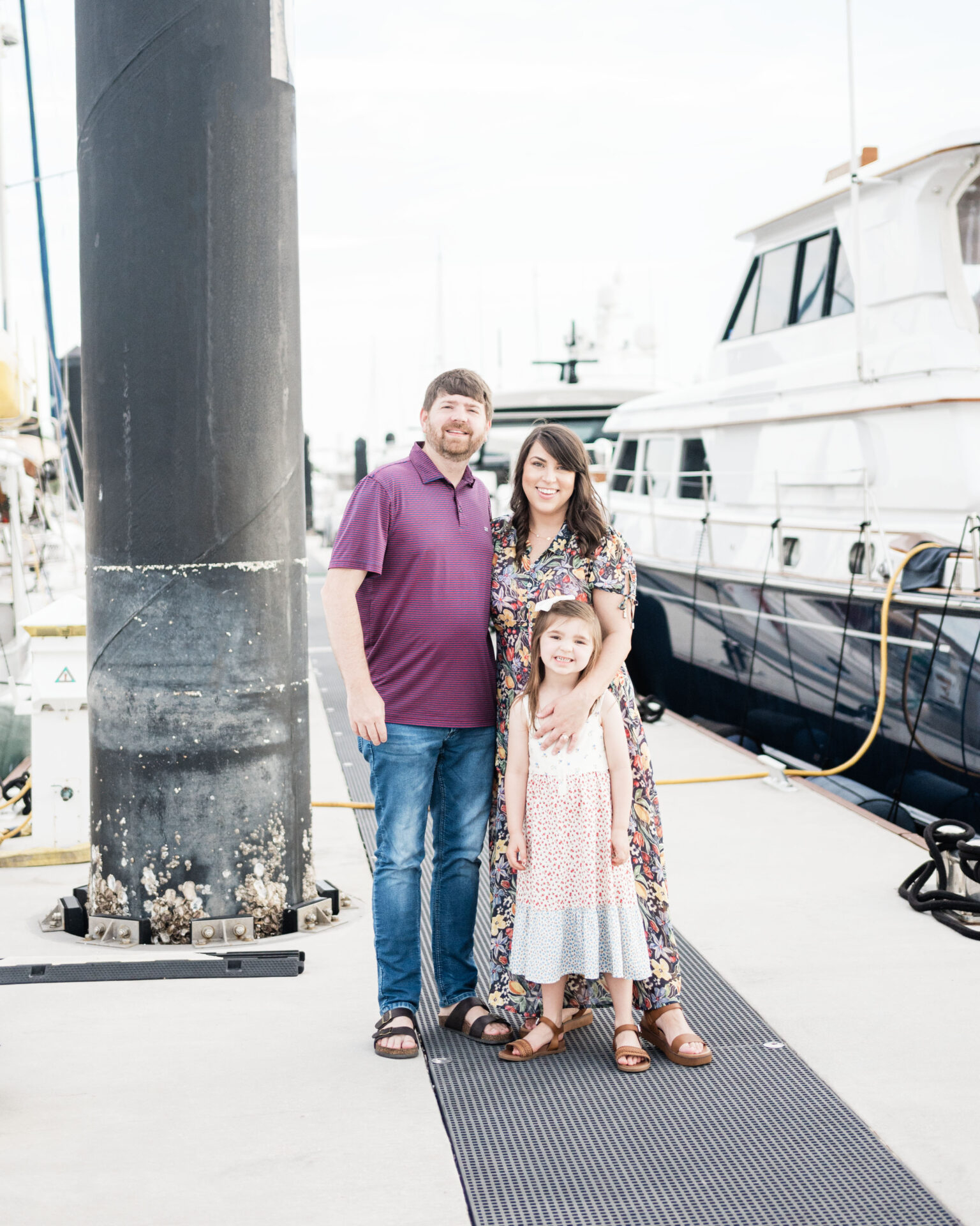 a group of people posing for a picture on boat dock in amelia island