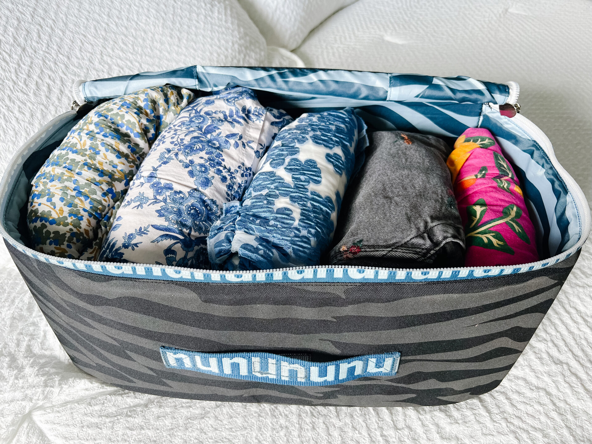 Nuuly vs Rent the Runway, image showing how Nuuly packages arrive in cloth tote with clothing items neatly folded inside.