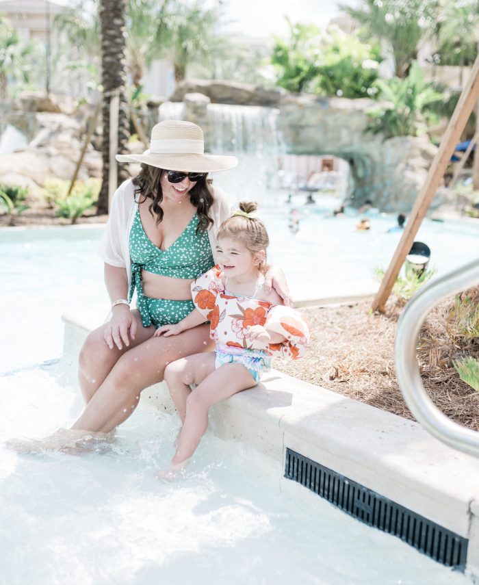 brittney naylor and child sitting on ledge of pool at the gaylord palms in orlando