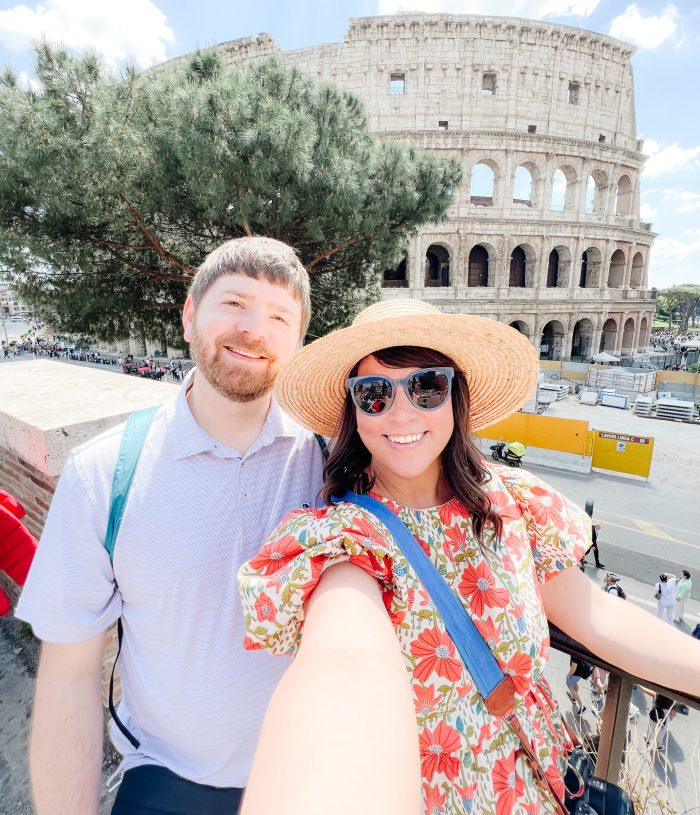 John and Brittney Naylor taking a selfie in front of one of the seven wonders of the world, the colosseum in Rome, Italy. 36 hours in Rome, tips & tricks for traveling to Italy as first timers